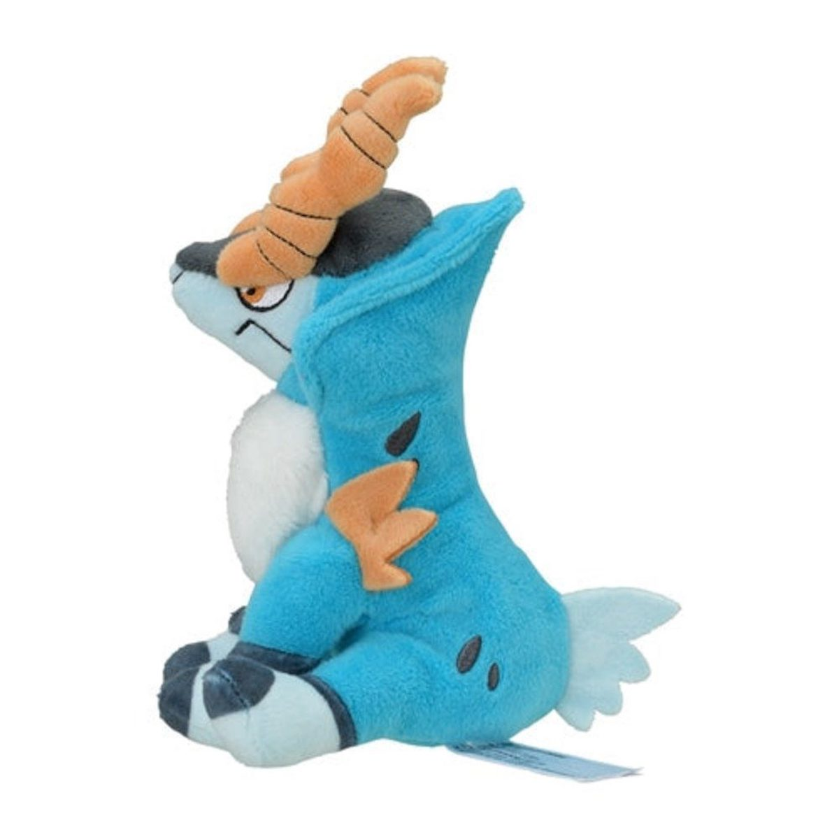Ein blaues Plüschtier mit orangen Hörnern, weißer Brust und schwarzen Flecken. Es sitzt.