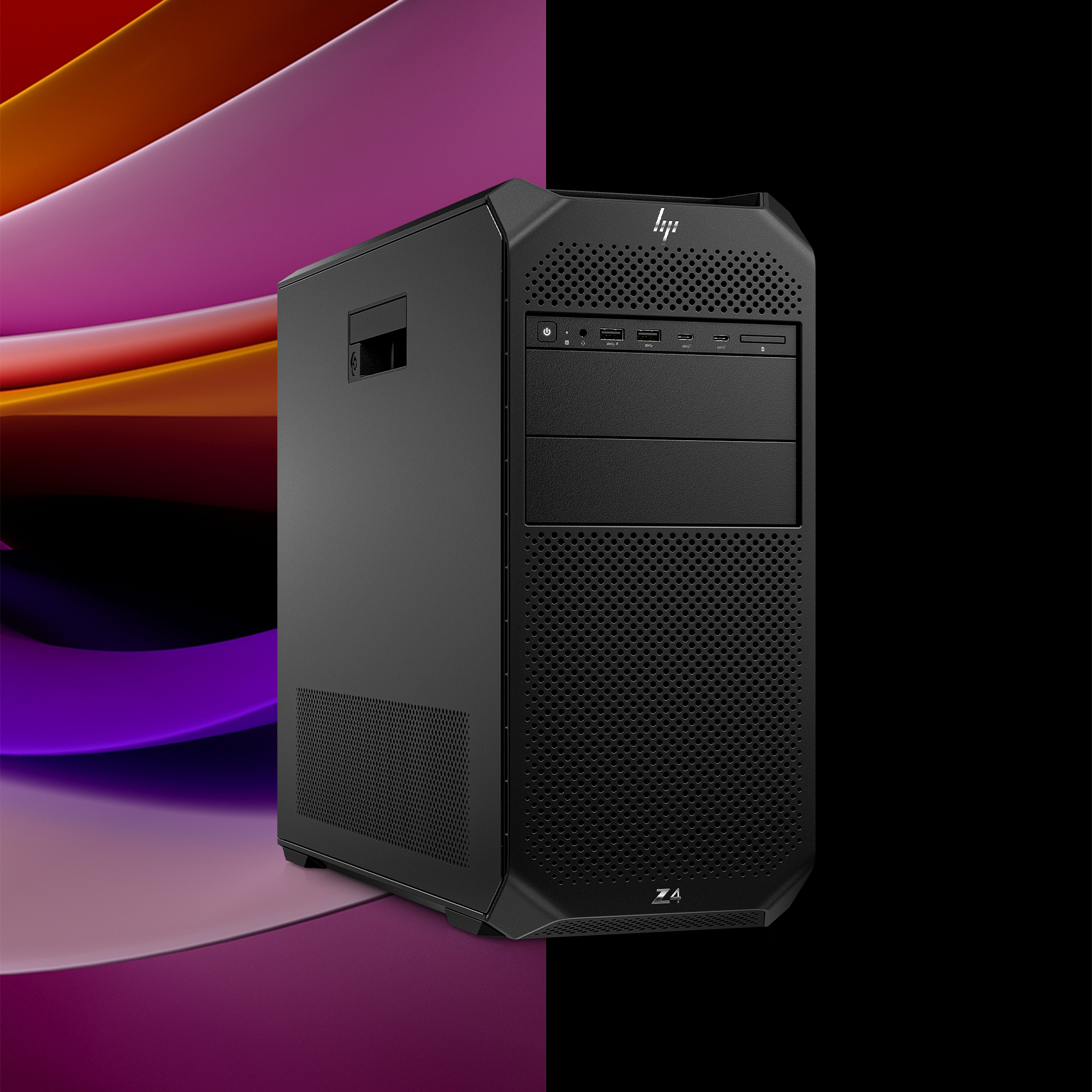 Un computer desktop nero su uno sfondo sfumato di tonalità viola e arancioni.