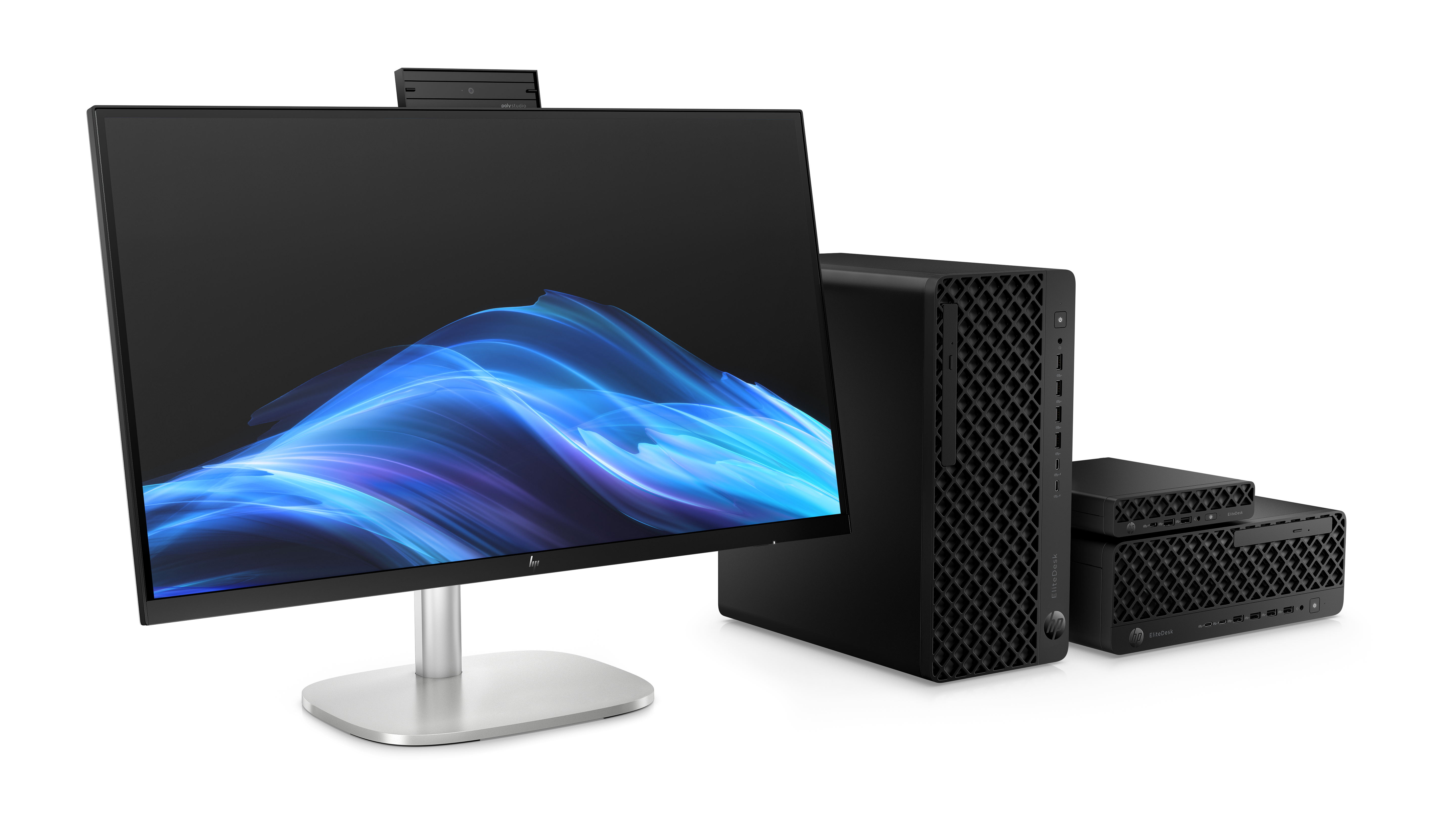 Une configuration informatique avec un moniteur, une tour et deux petits appareils. Le moniteur affiche des vagues bleues et blanches.