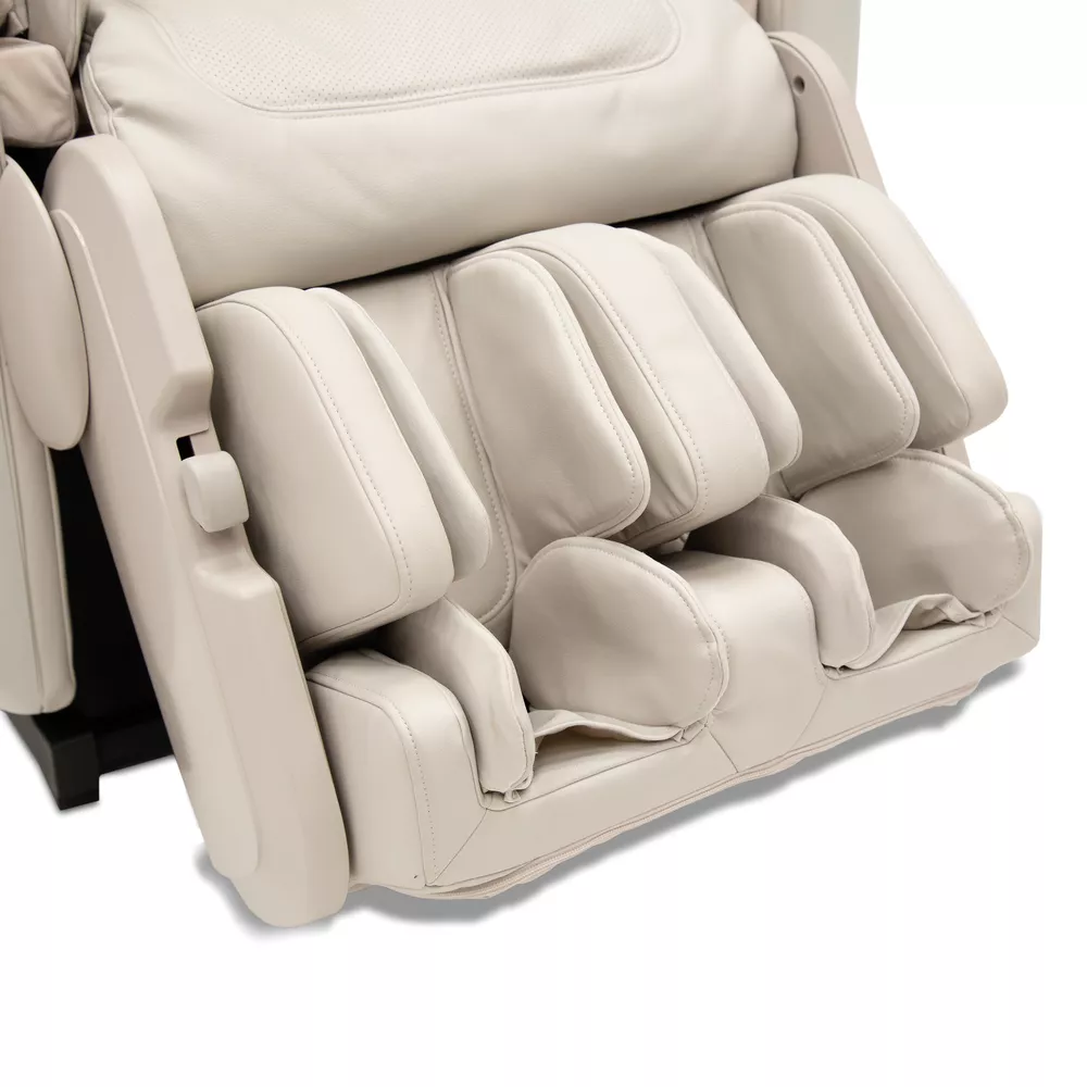 Close-up of a massage chair. Beige color, with many cushions and a black base.