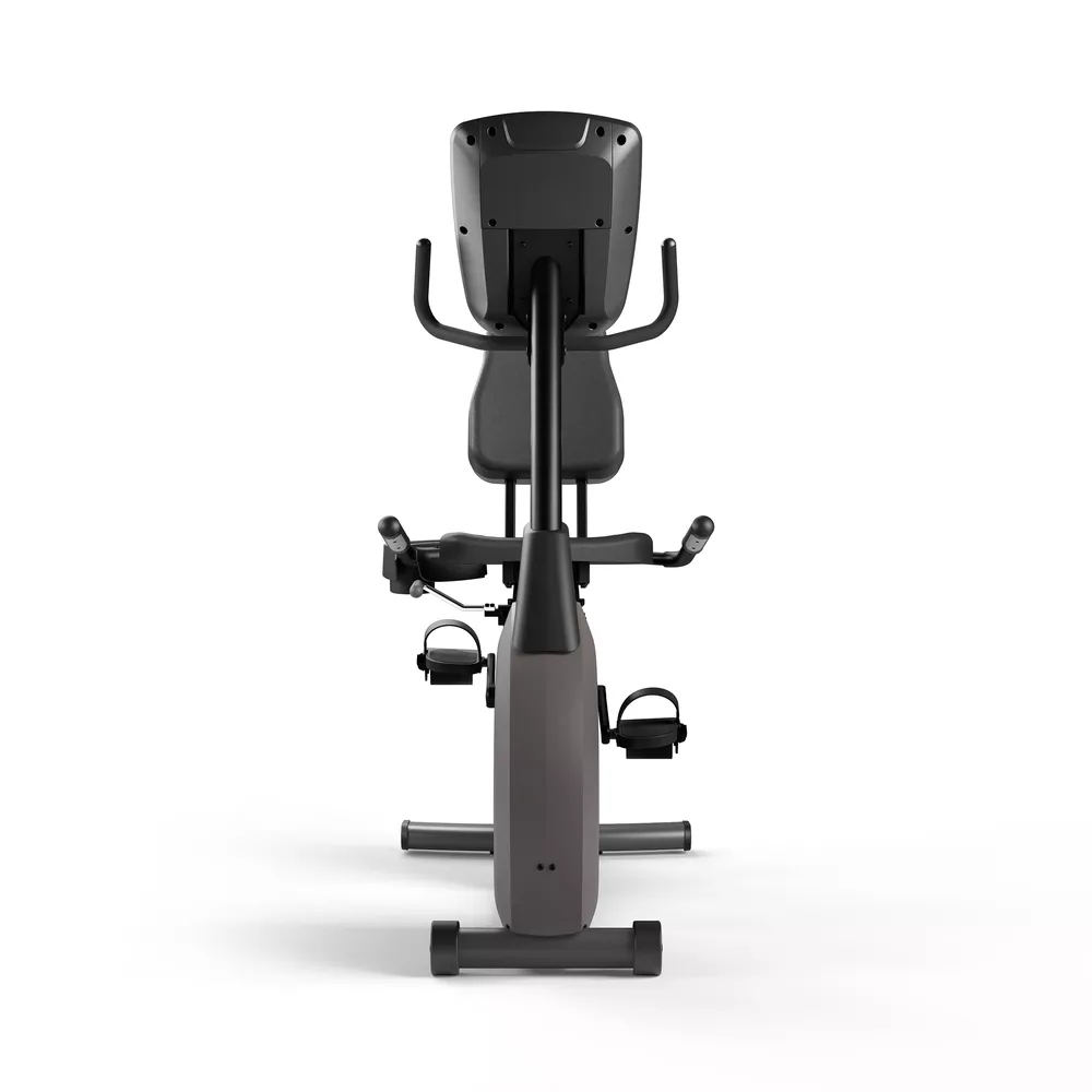 Vélo stationnaire de l'arrière. Il est gris avec une selle, un guidon et des pédales noirs.