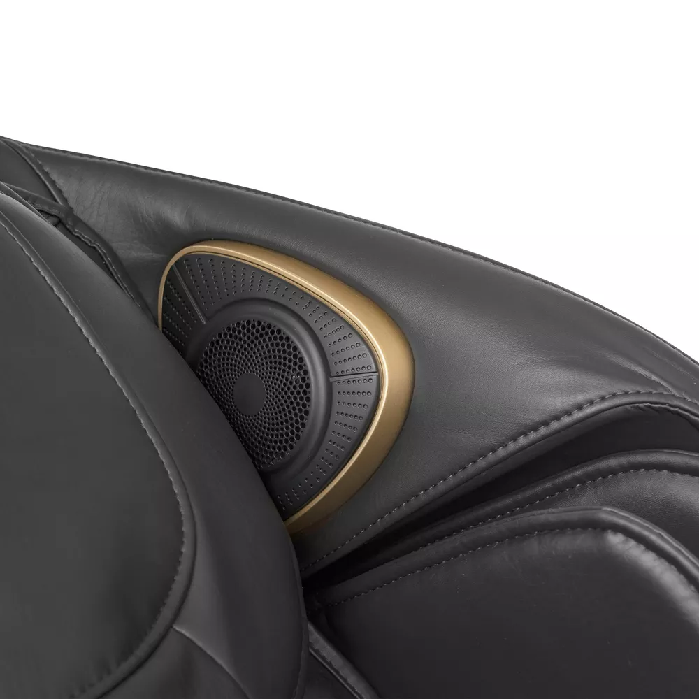 A close-up of a black massage chair speaker with a golden trim.