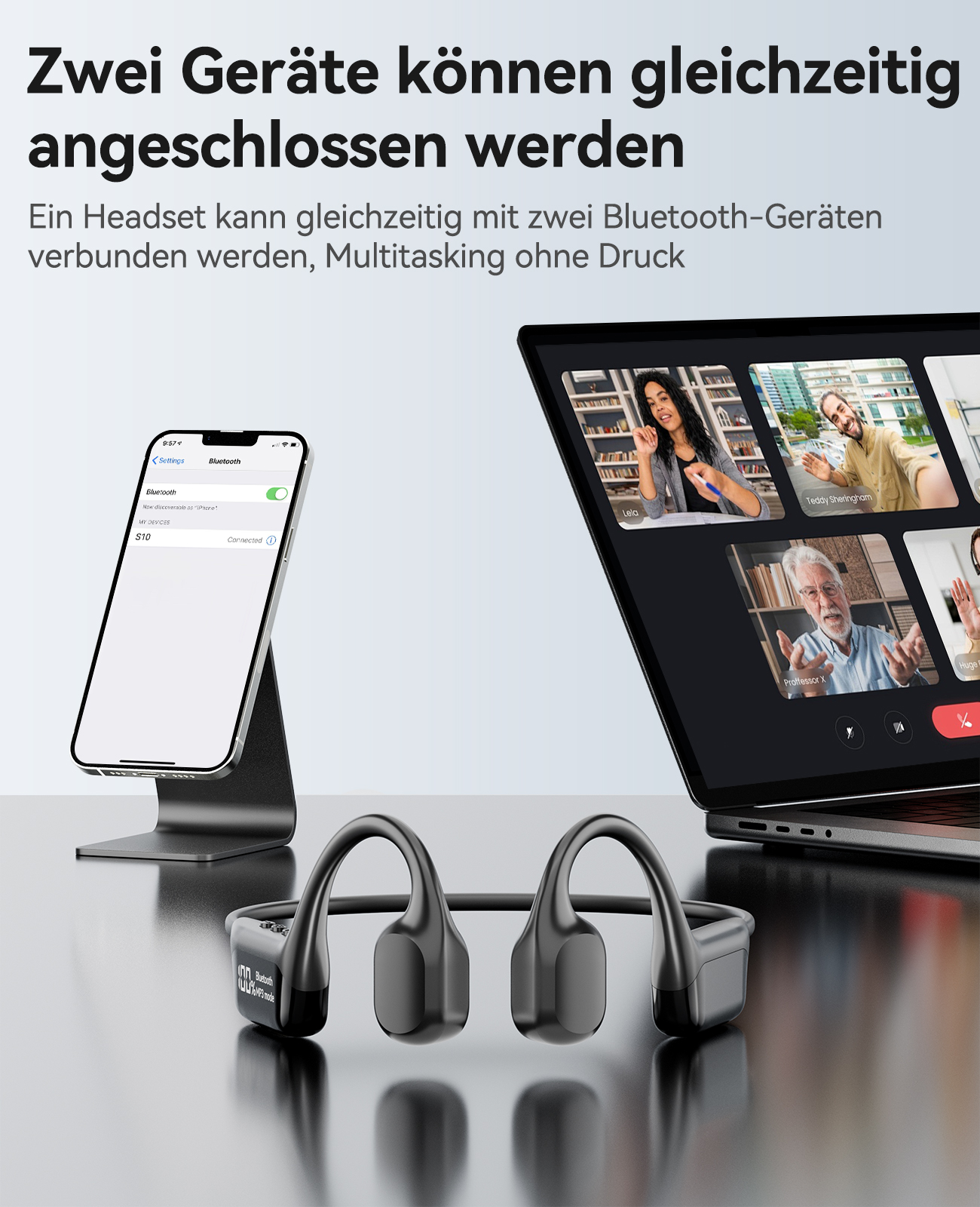 Knochenleitungskopfhörer, ein Smartphone und ein Laptop, der Videoanrufe anzeigt, auf einem Tisch. Die Kopfhörer sind sichtbar.