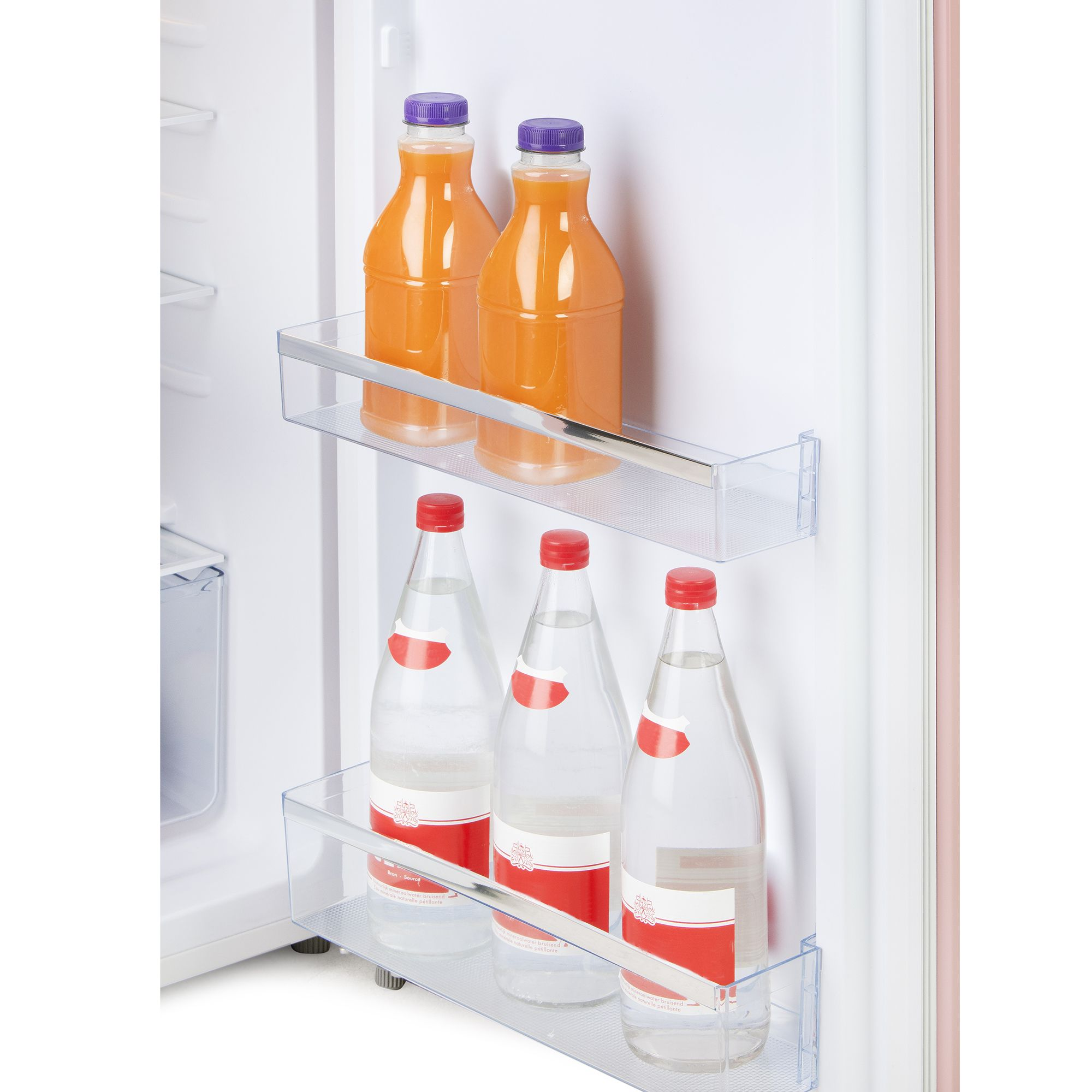 Interno del frigorifero con bottiglie di succo e acqua sugli scaffali. Porta del frigorifero rosa.