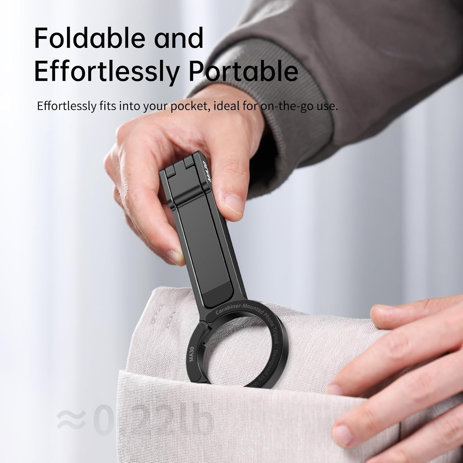Image shows a person putting a folded phone holder into a pocket, emphasizing portability and compact size.