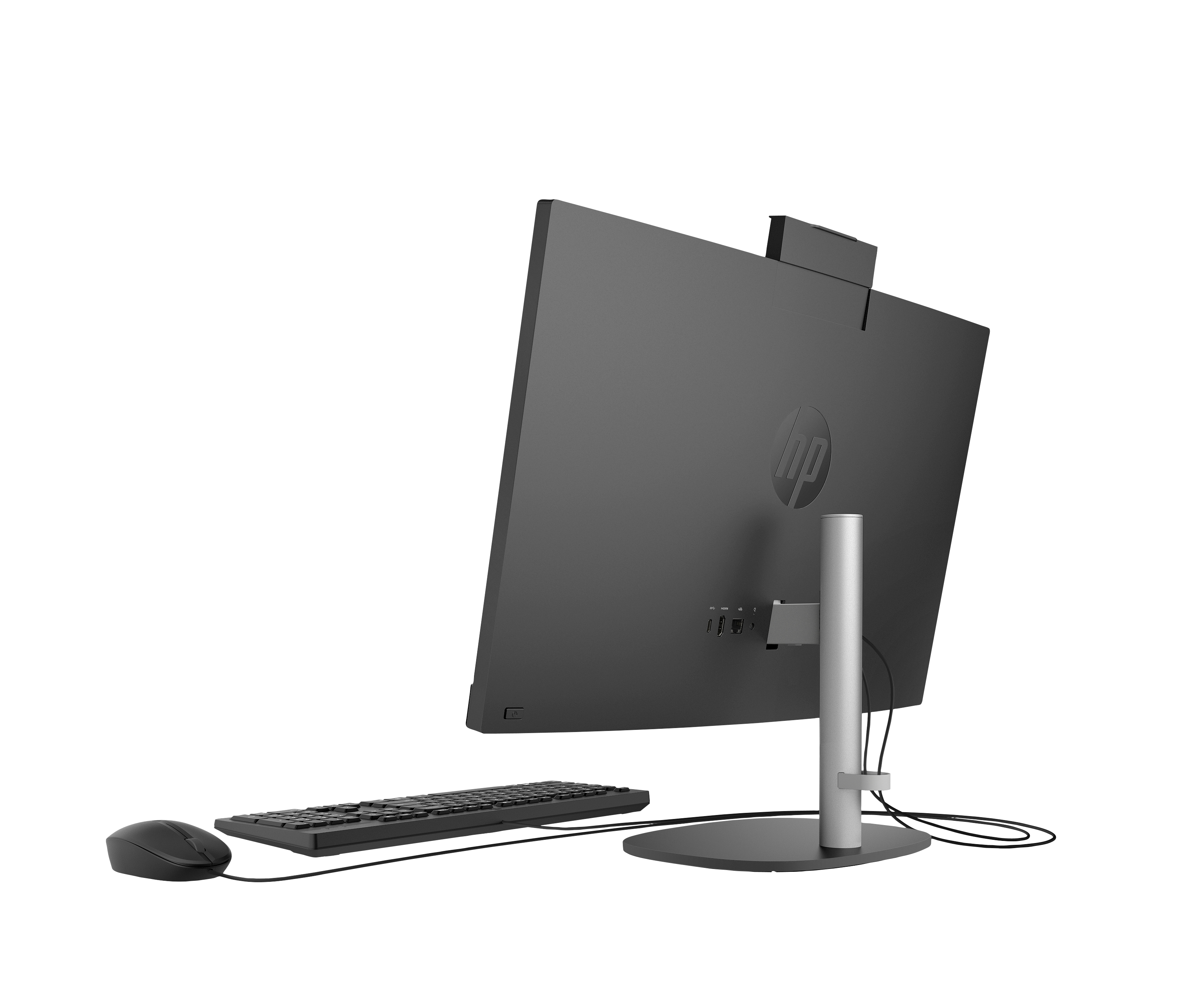 Komputer HP all-in-one. Widoczny tył, z klawiaturą i myszą z przodu. Monitor jest szary i ma logo HP.