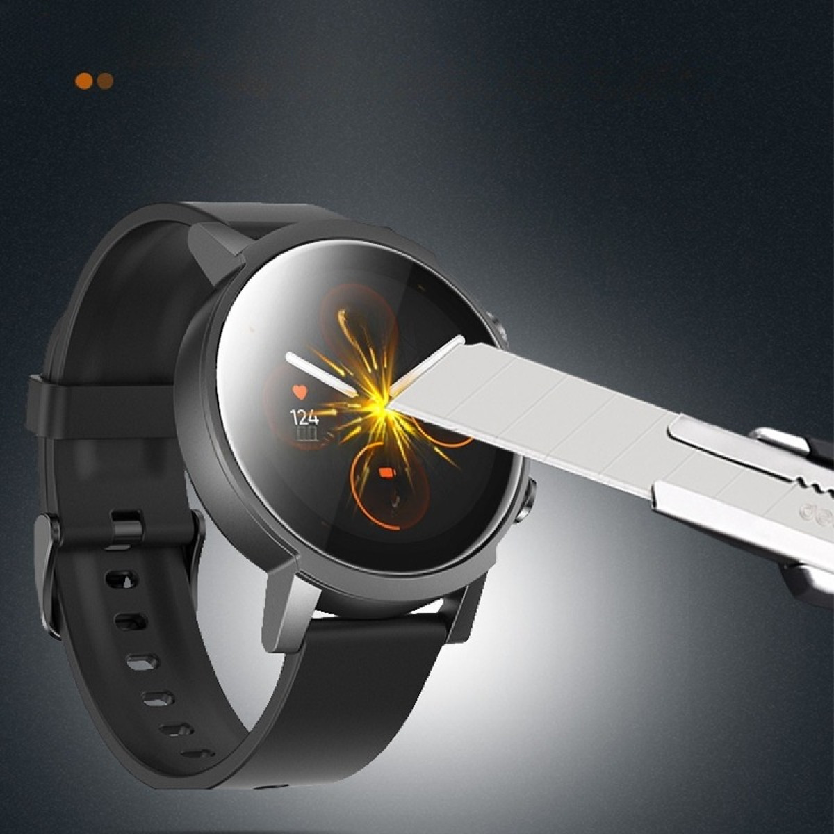 Uno smartwatch nero viene testato con un taglierino. Il quadrante mostra una frequenza cardiaca di 124. Lo sfondo è grigio scuro.