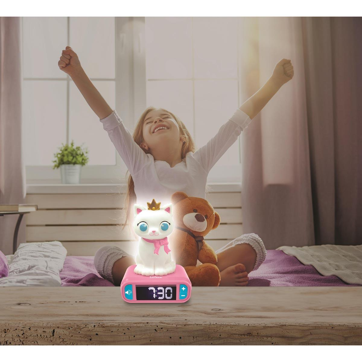 Una niña con los brazos levantados sonríe. Un despertador con forma de gato y un oso de peluche están en una cama. La luz brilla.
