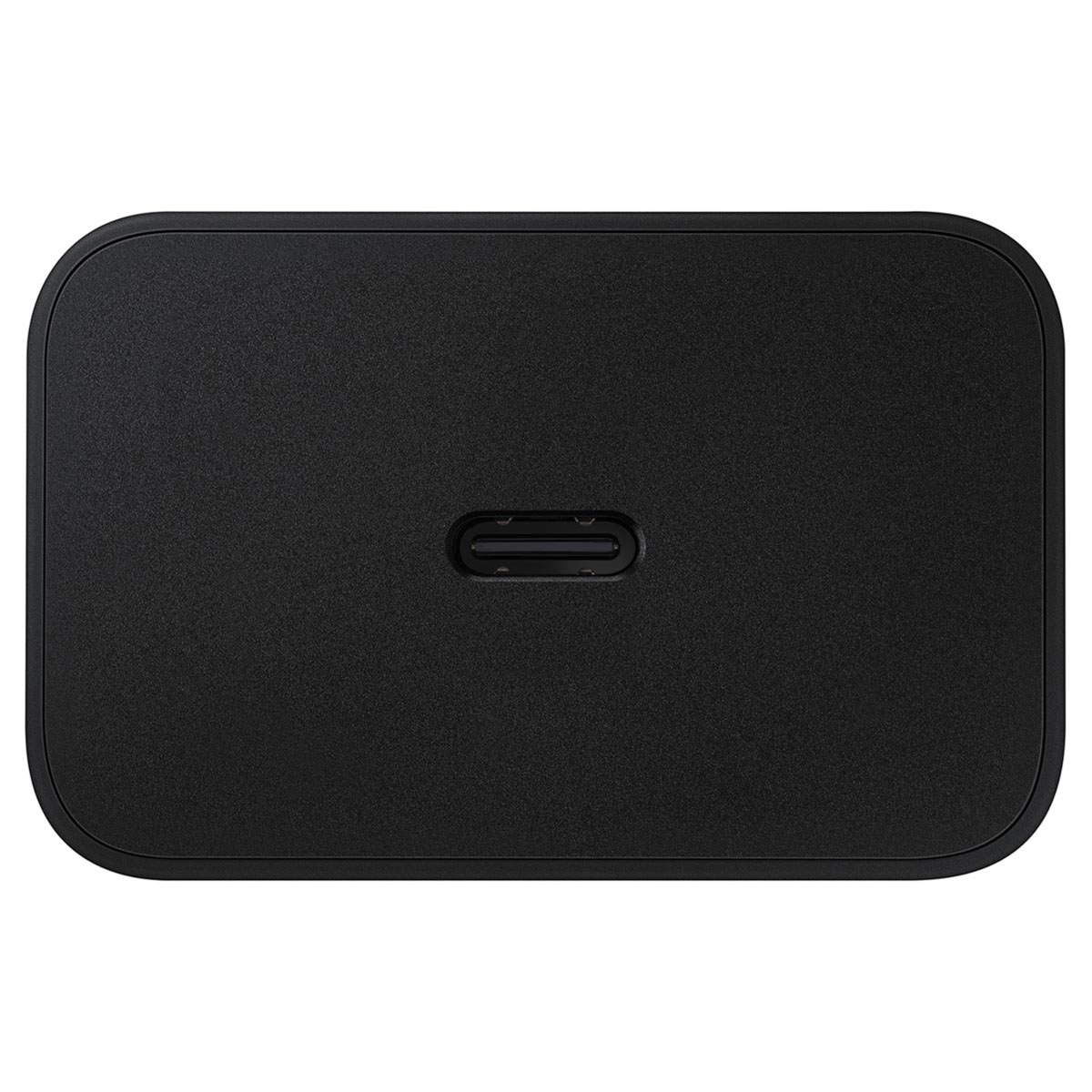 Un adaptador de corriente negro y rectangular con esquinas redondeadas. Tiene un puerto central ovalado en la parte inferior.