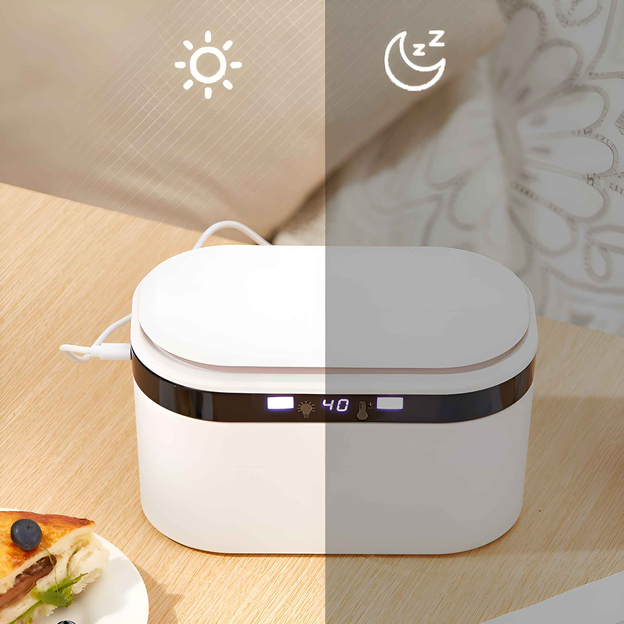 Eine weiße Box mit Digitalanzeige, ein Sandwich mit Blaubeere und ein Sonnen- und Mondsymbol.