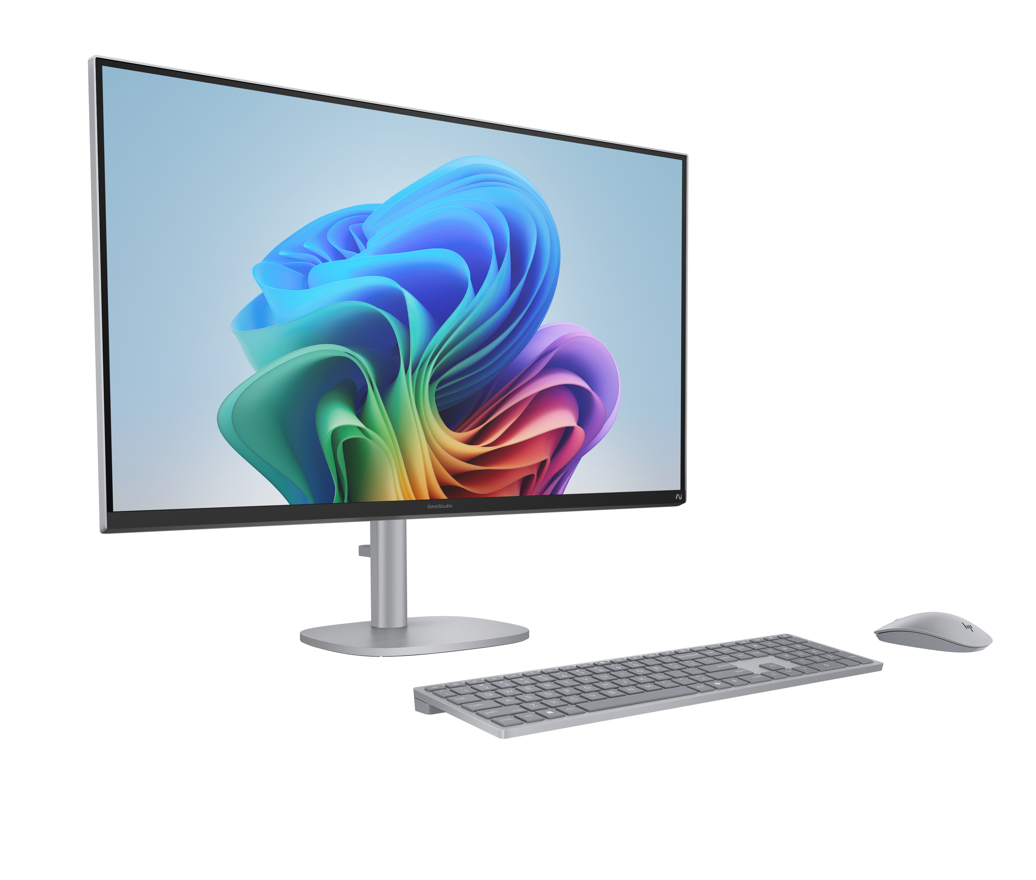 Monitor, klawiatura i mysz na białej powierzchni. Monitor wyświetla kolorowy, abstrakcyjny obraz.