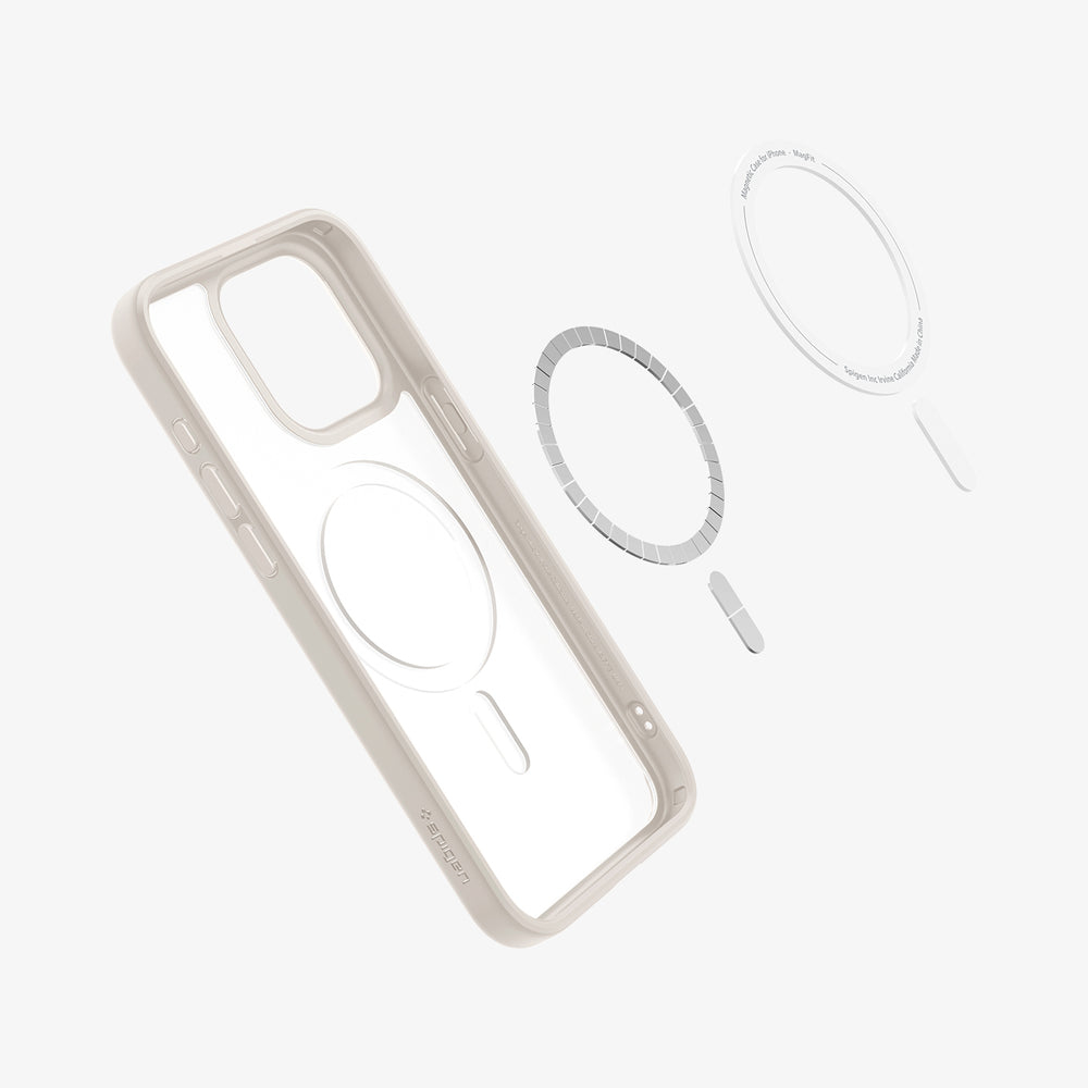 Een transparante telefoonhoes met een lichtbruin frame. Onderdelen zijn een magnetische ring, een witte ring en een zilveren staafje.