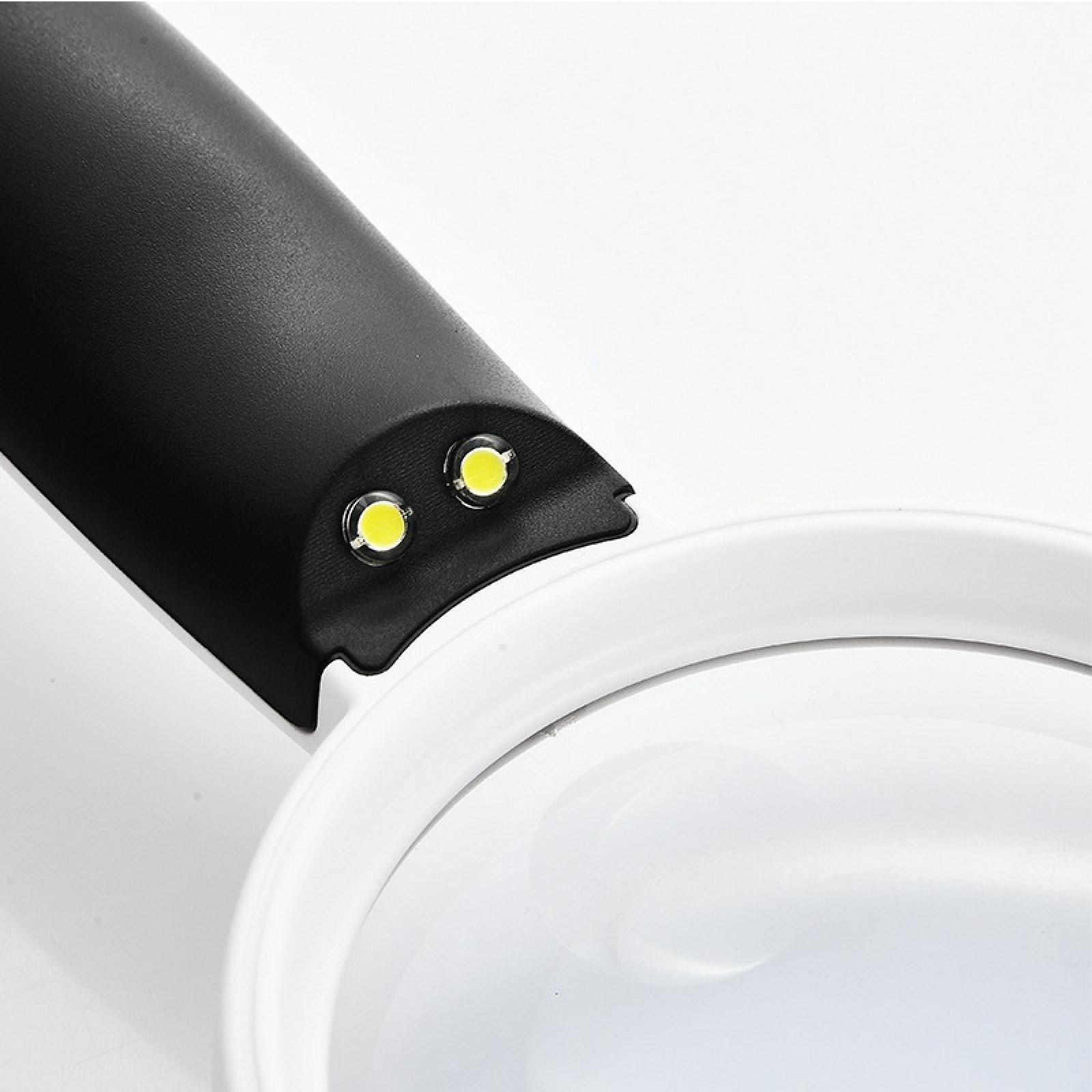 Nahaufnahme einer Lupe mit schwarzem Griff. Zwei LED-Leuchten sind eingeschaltet. Der Hintergrund ist weiß.