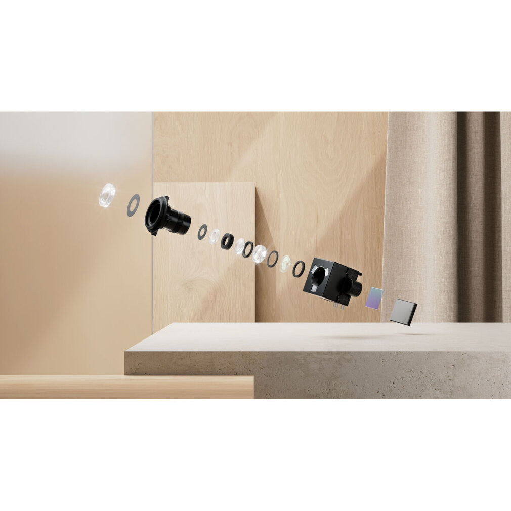 Wyświetlane są komponenty aparatu. Obraz przedstawia zdemontowany aparat z obiektywami i czujnikami unoszącymi się nad platformą.