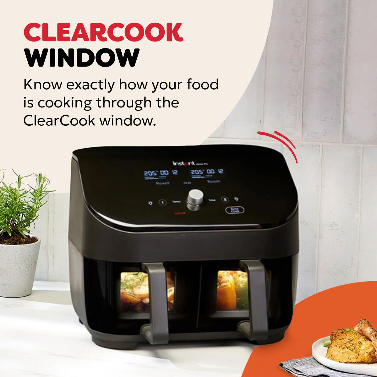 Schwarze Heißluftfritteuse mit ClearCook-Fenster, das Essen im Inneren zeigt. Text sagt ClearCook Window. Eine Pflanze und ein Teller mit Essen sind sichtbar.
