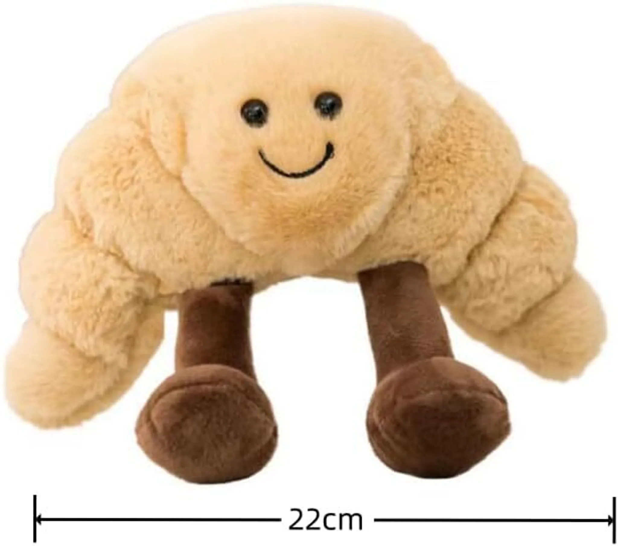 Ein Plüsch-Croissant-Spielzeug mit einem lächelnden Gesicht, schwarzen Augen und braunen Füßen, 22 cm lang.