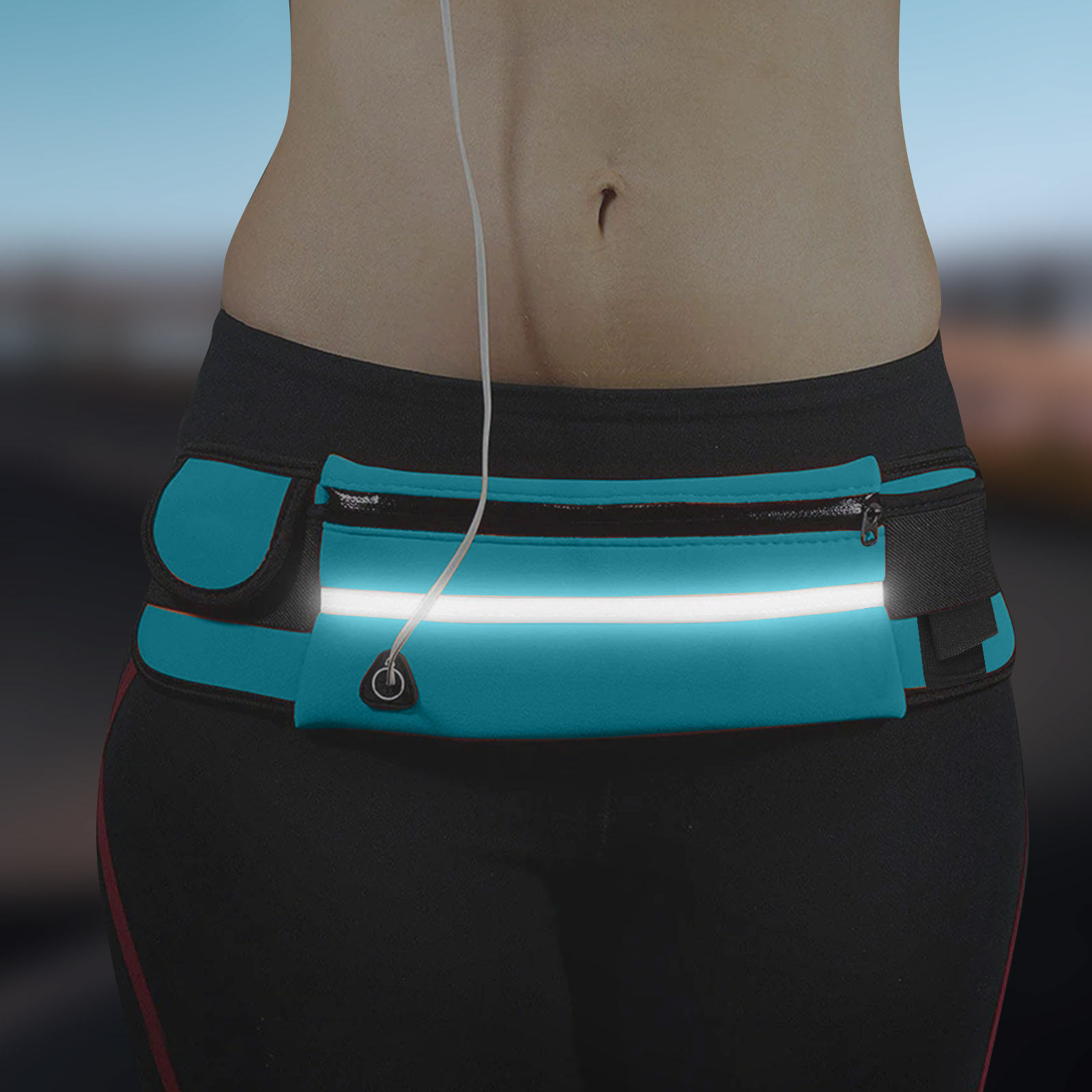 Eine Person, die einen tealfarbenen Laufgürtel mit reflektierendem Streifen trägt. Kopfhörerkabel hängen herunter. Die Person trägt eine schwarze Leggings.