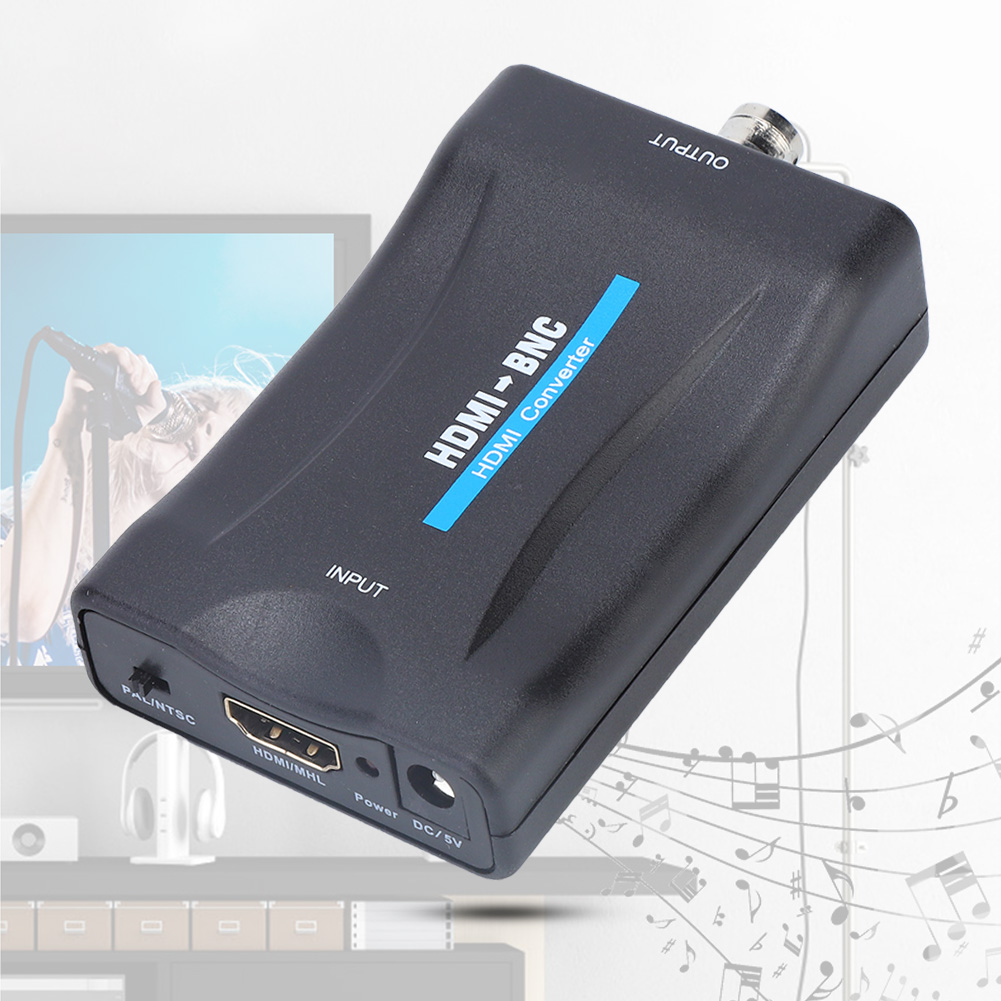 Ein schwarzer HDMI-zu-BNC-Konverter. Beschriftungen sind 'Input', 'Output' und 'HDMI-BNC'. Im Hintergrund ist ein verschwommenes Bild einer Person zu sehen.