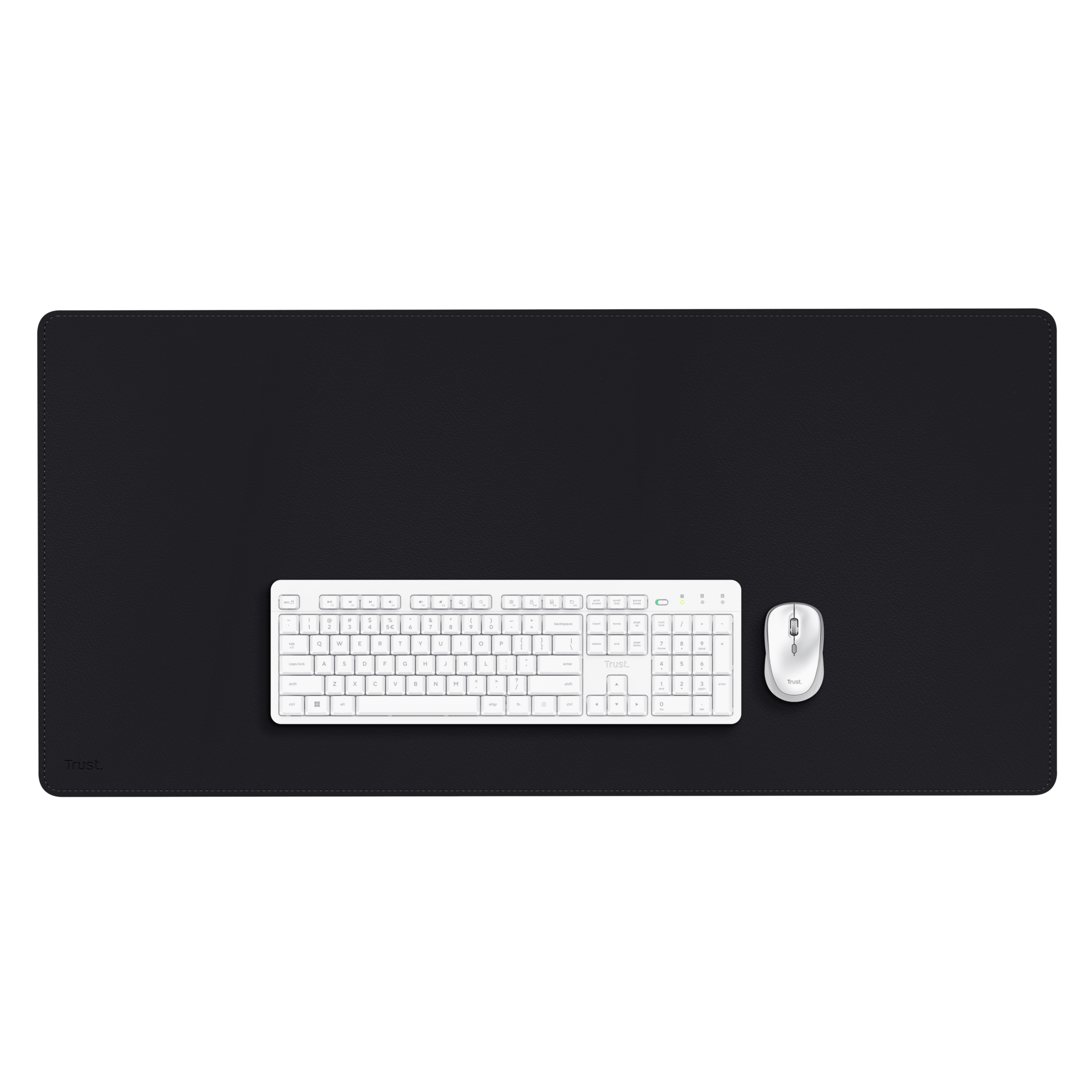 A white keyboard and mouse sit on a black desk mat. The mat and background are black.