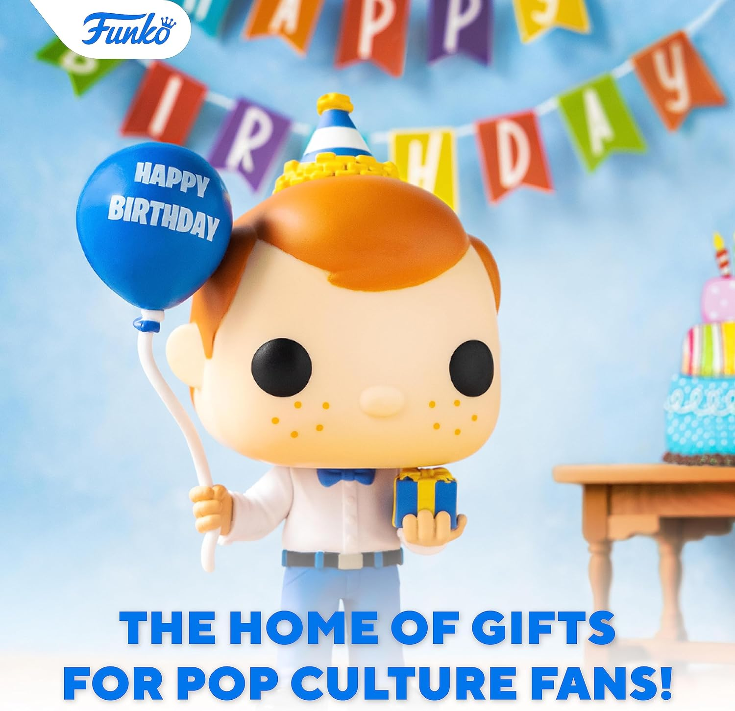 Una figura Funko Pop con un palloncino blu che dice "Happy Birthday". Tiene in mano una scatola regalo, con uno striscione di compleanno sullo sfondo.