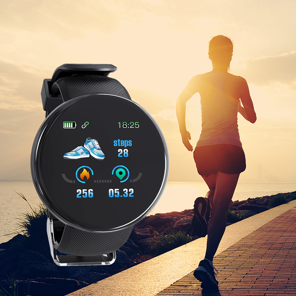 Frau, die mit einer Smartwatch läuft. Die Uhr zeigt Zeit, Schritte und andere Fitnessdaten an. Sonnenuntergang im Hintergrund.