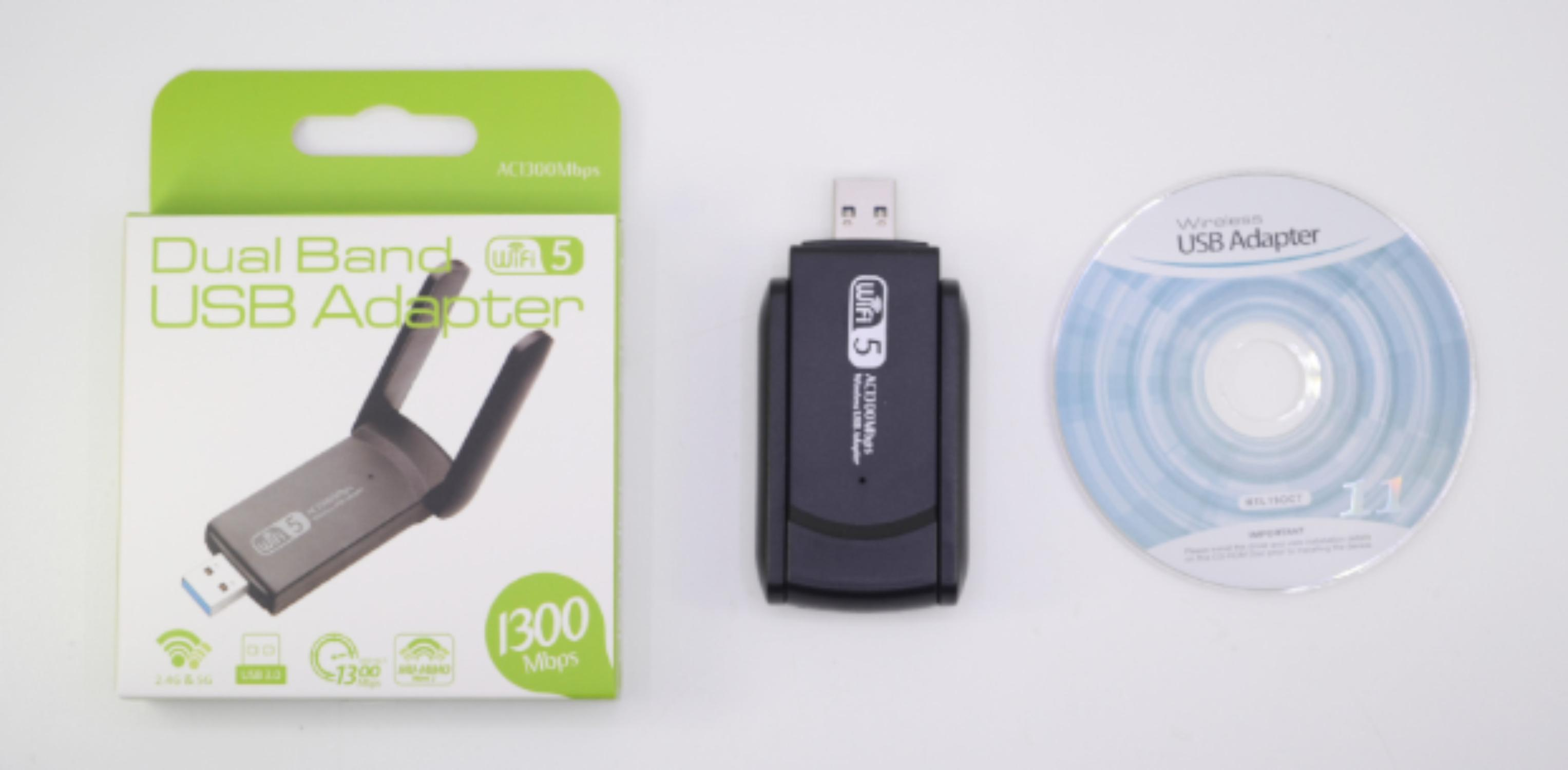 Das Bild zeigt einen Dualband-USB-Adapter, einen USB-Adapter und eine CD. Die Adapterbox ist grün und weiß.