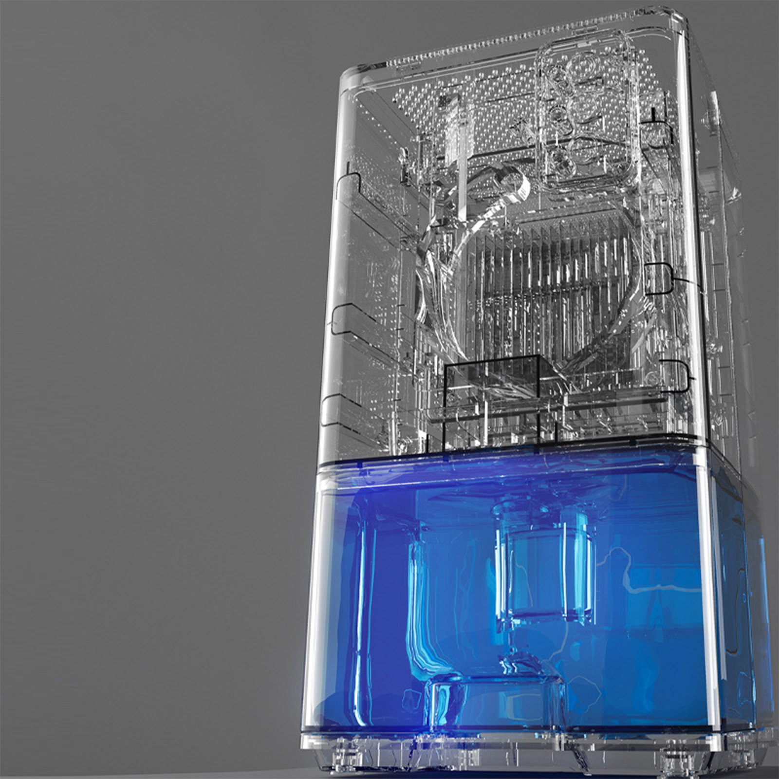 Ein transparentes Gerät mit blauer Flüssigkeit am Boden. Interne Komponenten sind sichtbar. Grauer Hintergrund.