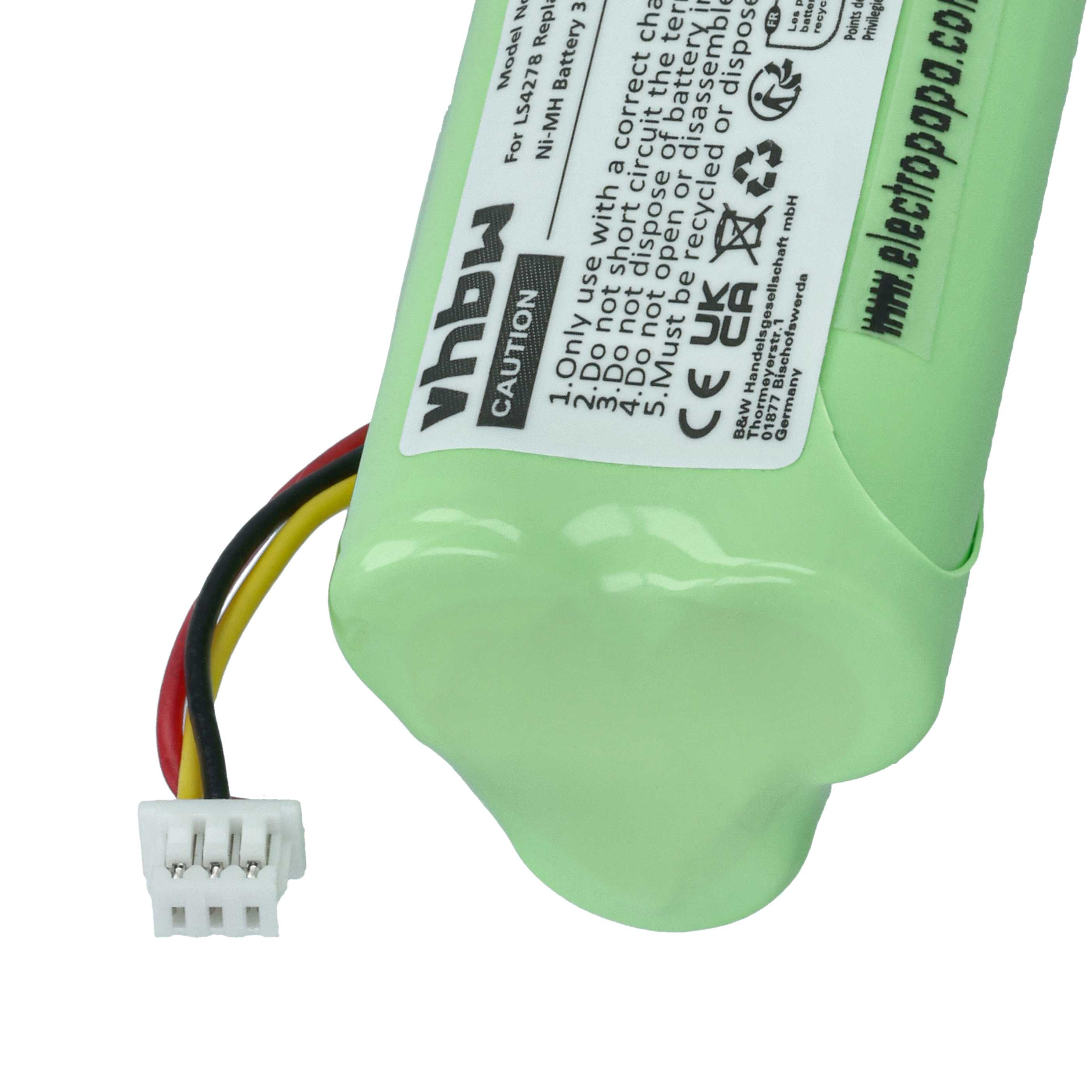 Eine grüne Batterie mit weißem Stecker und schwarzen, gelben und roten Drähten. Text auf der Batterie enthält Warnhinweise.