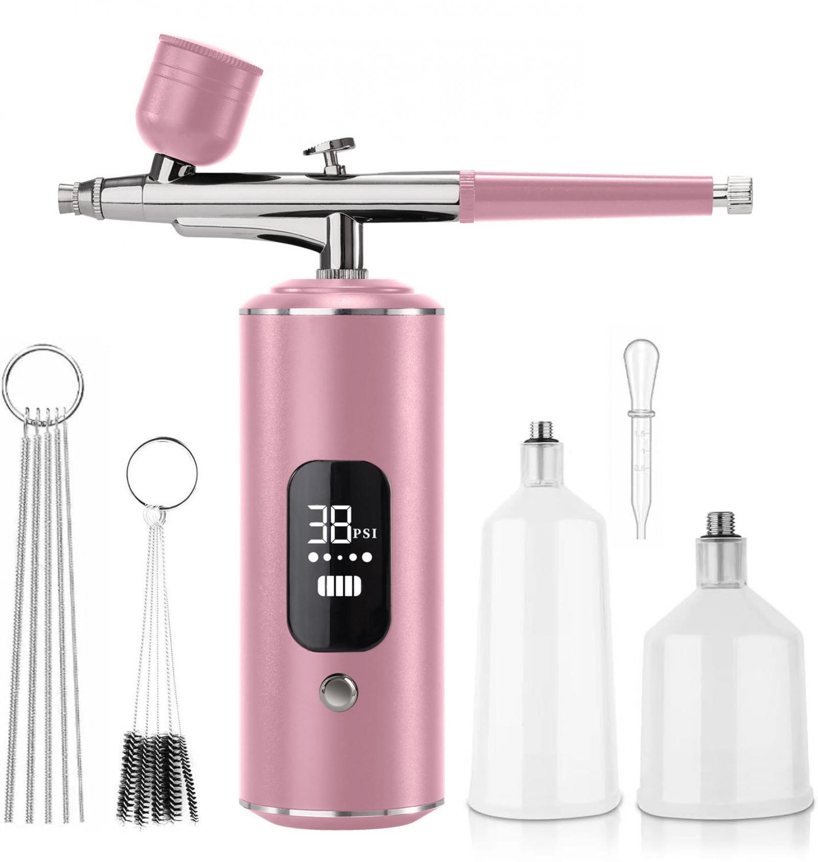 Ein rosa Airbrush-Kit mit Zubehör, darunter Reinigungsbürsten, Flaschen und eine digitale Druckanzeige.