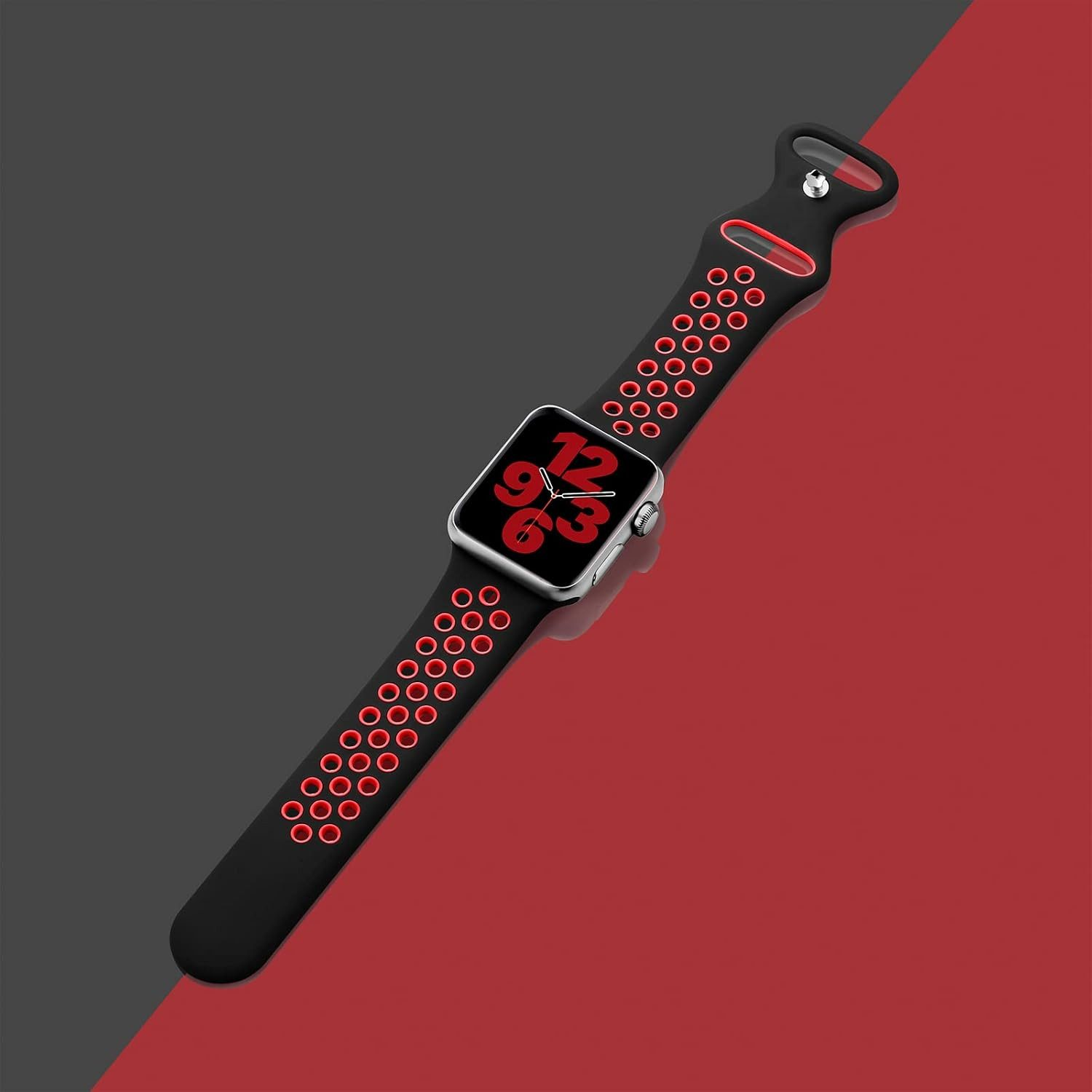 Apple Watch mit schwarzem und rotem Armband. Das Zifferblatt zeigt 12, 6 und 3. Hintergrund hat rote und graue diagonale Abschnitte.