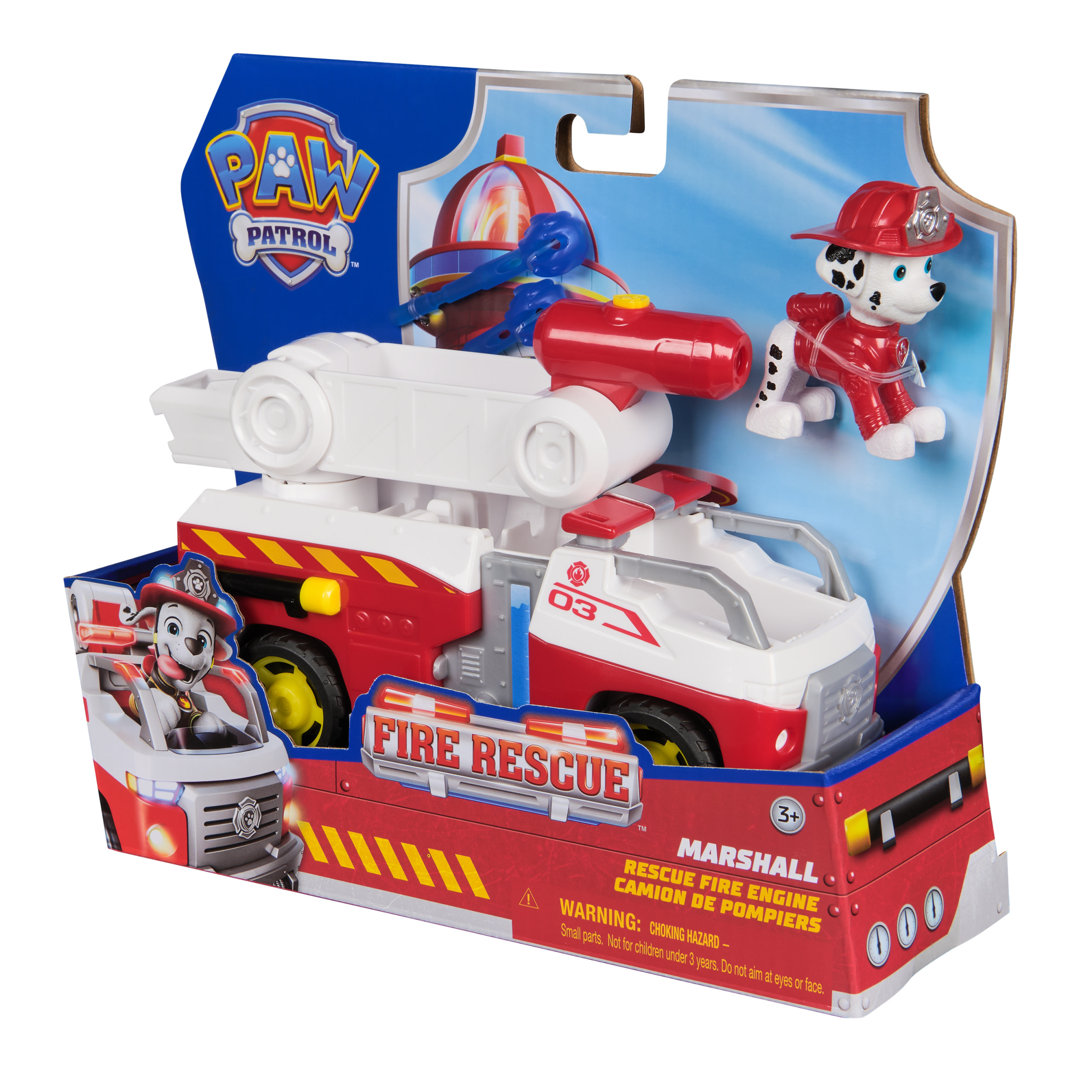 Un juguete de camión de bomberos de Paw Patrol en su caja, figura de Marshall incluida. La caja es roja, blanca y azul, con gráficos de rescate de bomberos.