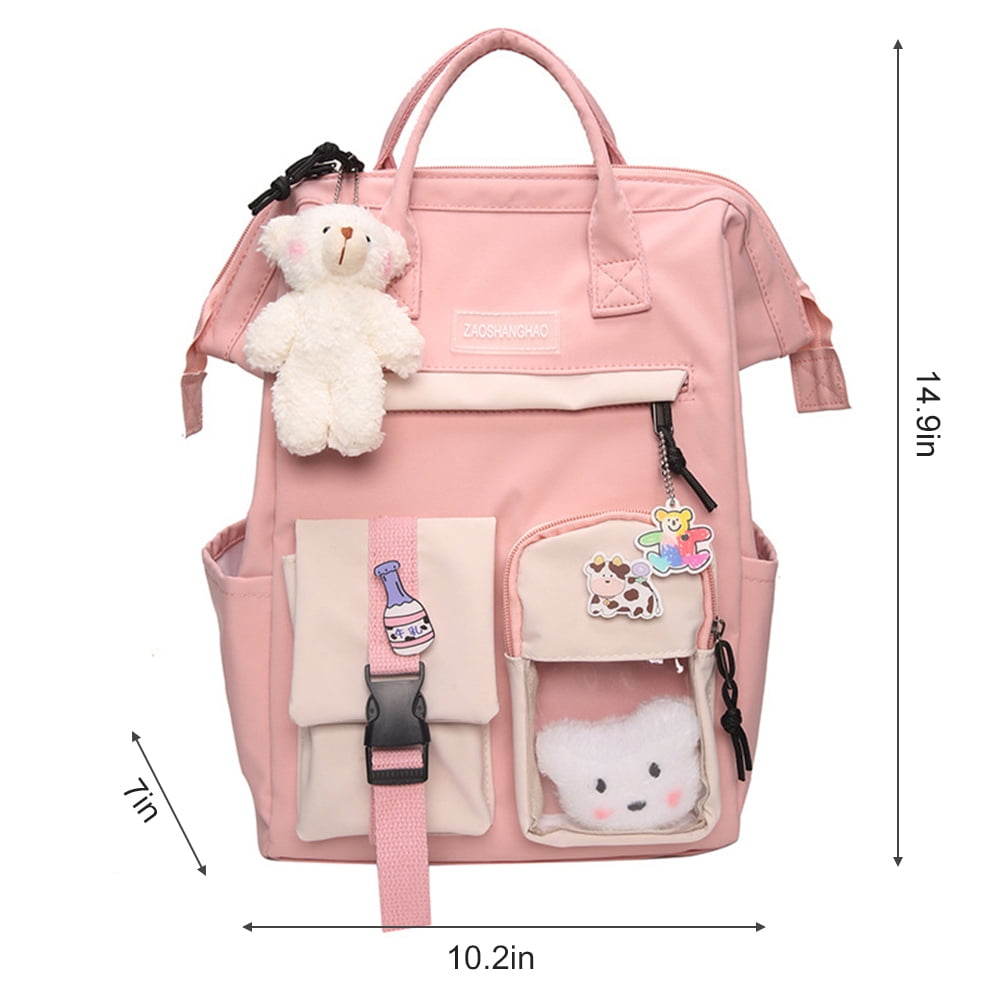 Rosa Rucksack mit mehreren Taschen, einem weißen Teddybär und dekorativen Anhängern. Abmessungen: 14,9 Zoll x 10,2 Zoll x 7 Zoll.