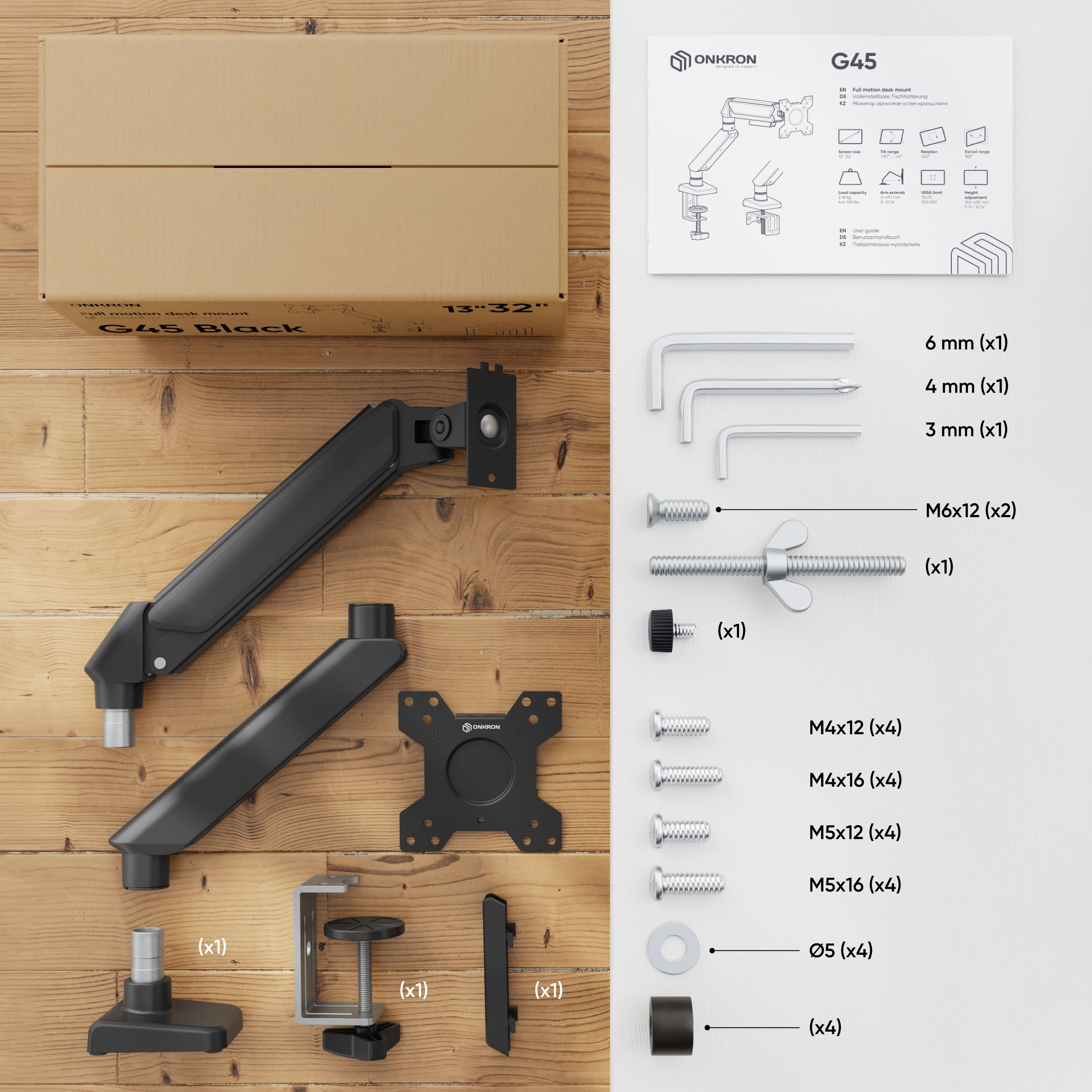 Un kit de montaje de escritorio negro con piezas, herramientas y una caja sobre madera, papel blanco a la derecha.