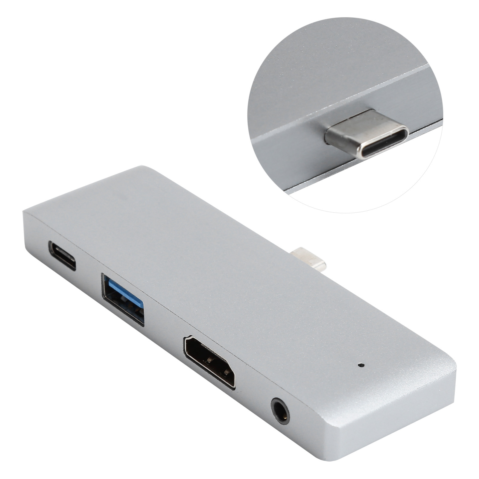 Ein silberner USB-Hub mit mehreren Anschlüssen, darunter USB, HDMI und Audio, und eine Nahaufnahme eines USB-C-Anschlusses.