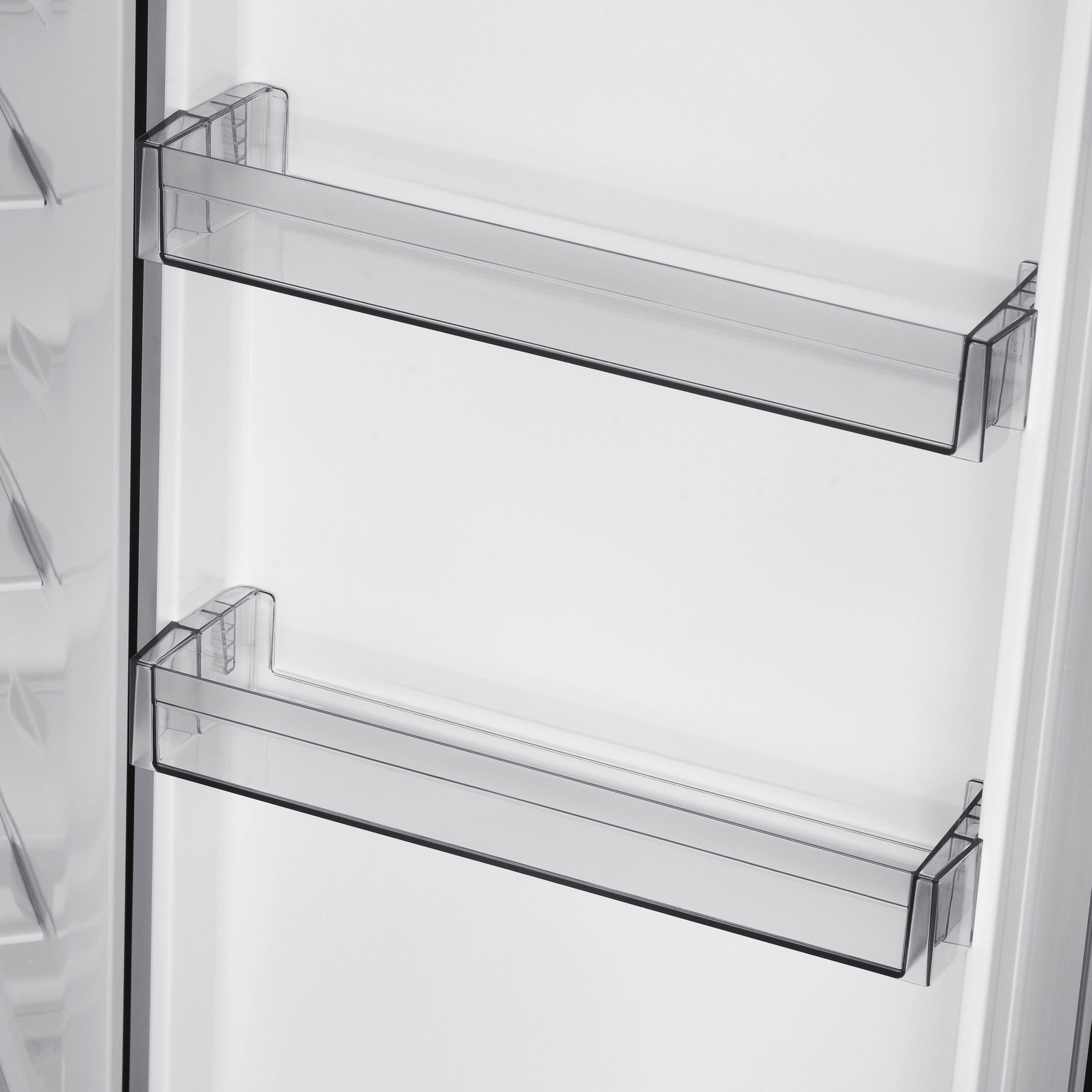 Inside a refrigerator, two clear plastic shelves are mounted on a white interior. The shelves are empty, with a clean design.