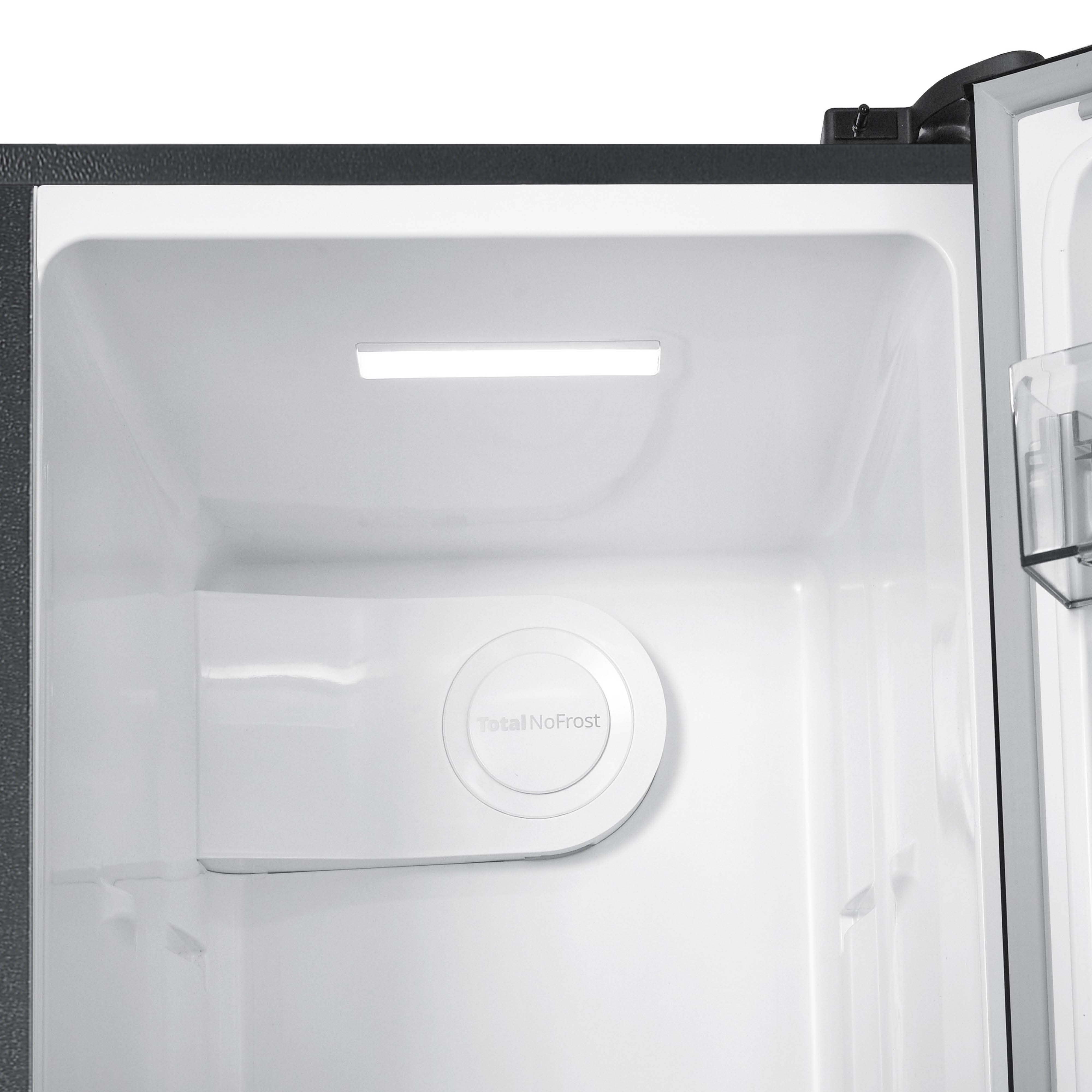 Inside a white refrigerator. A light strip is on top. A round 'Total NoFrost' logo is visible.