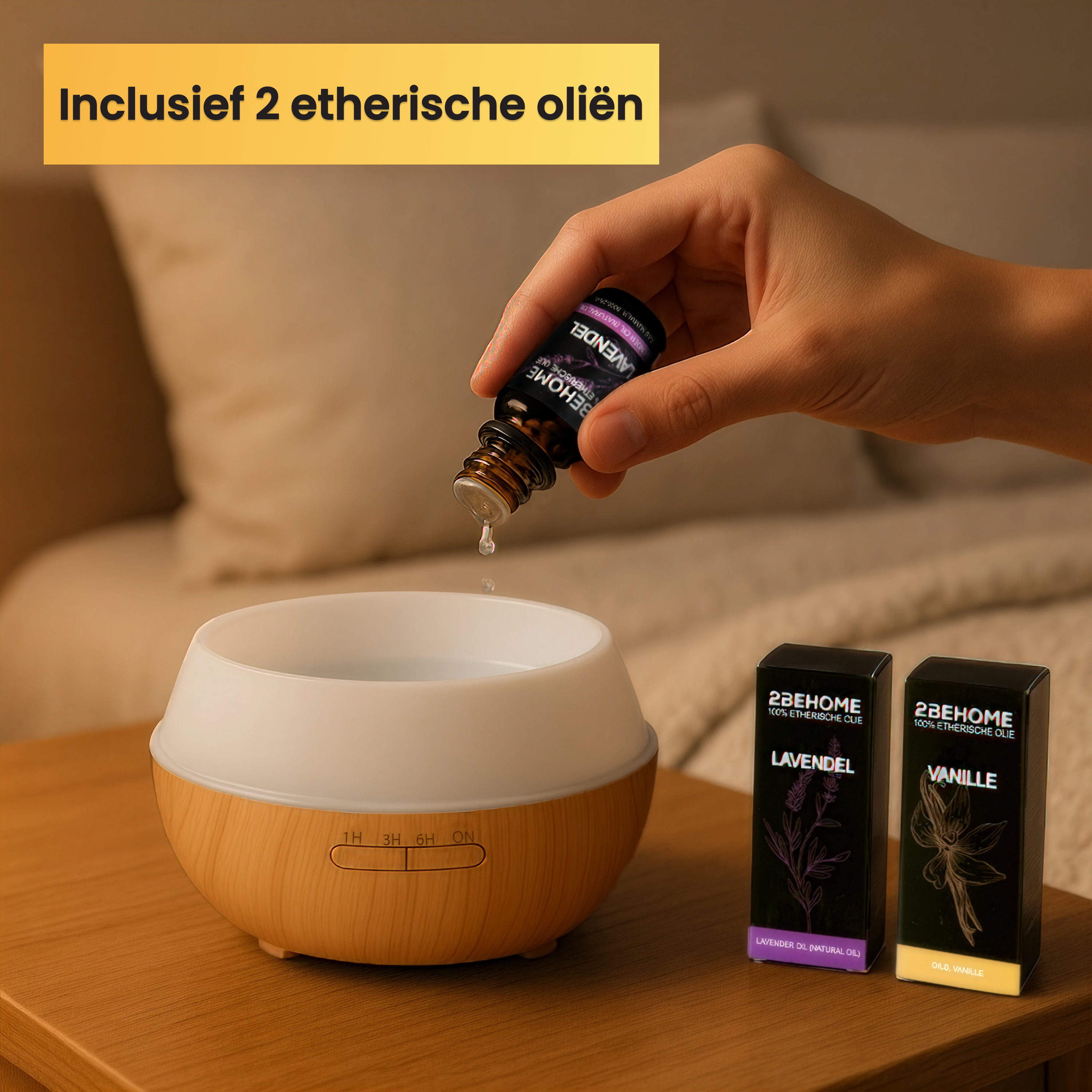 A hand pouring oil from a bottle into a diffuser. Two oil boxes are also on the table.