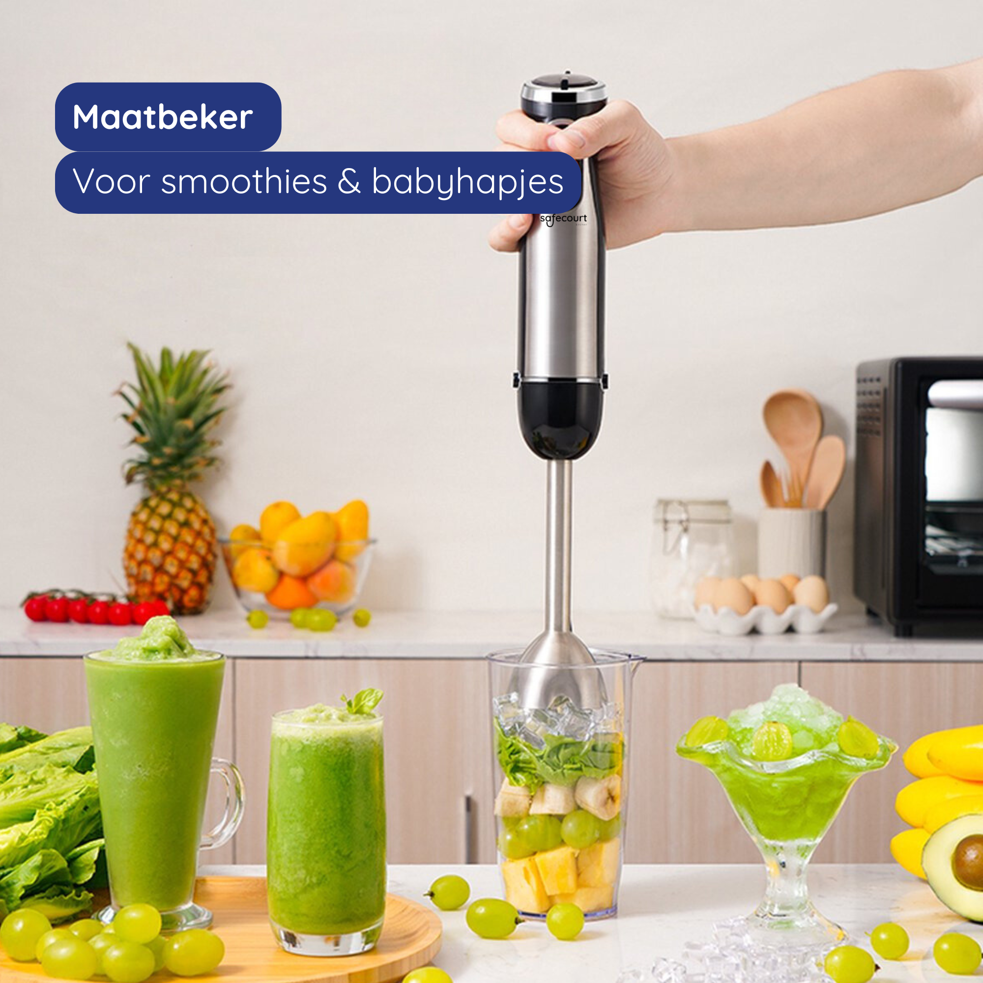 A hand holding a blender over a glass with fruit. Two green smoothies and a dish of green ice cream are on the table.