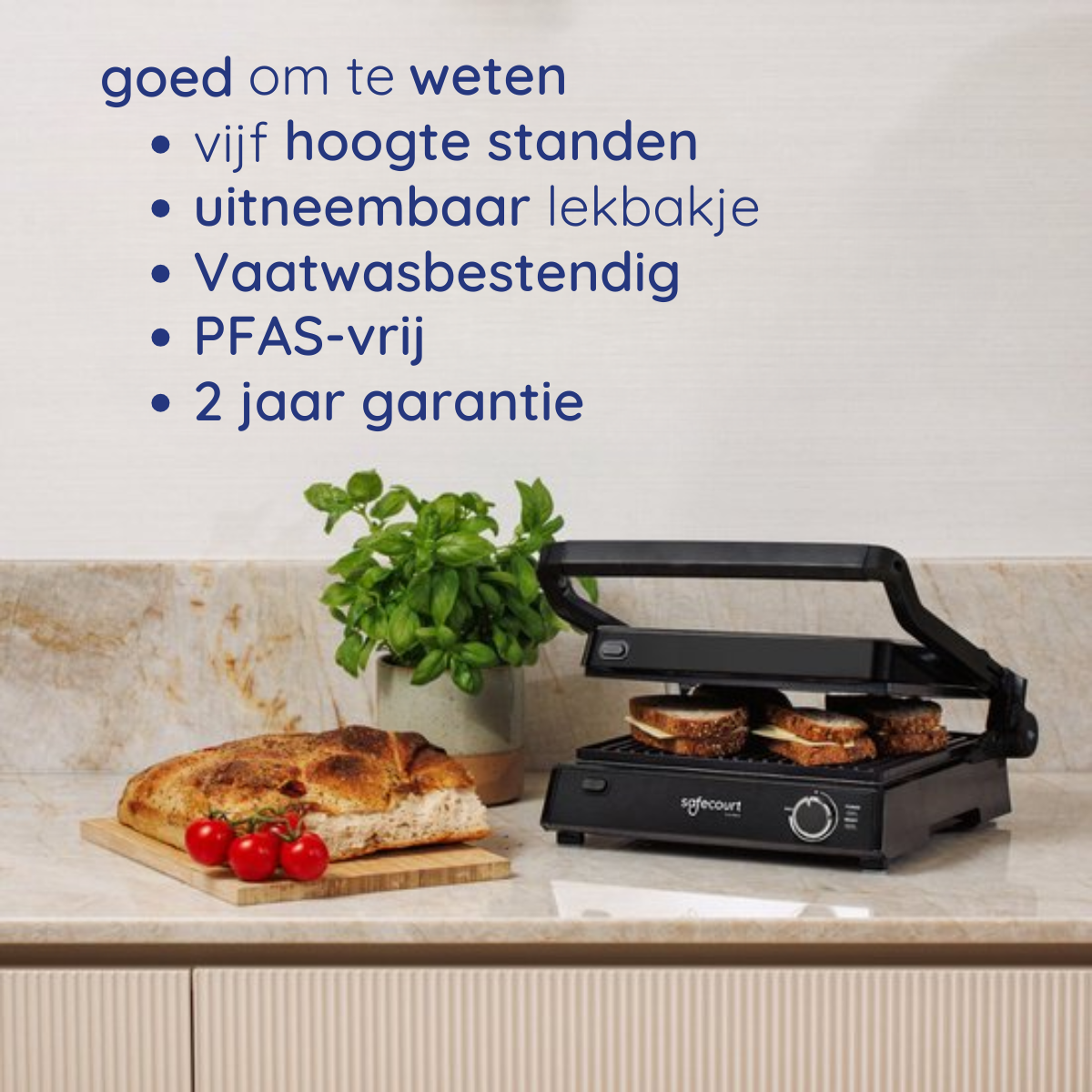 Zwarte sandwichmaker met sandwiches erin, brood en tomaten links. Nederlandse tekst erboven.
