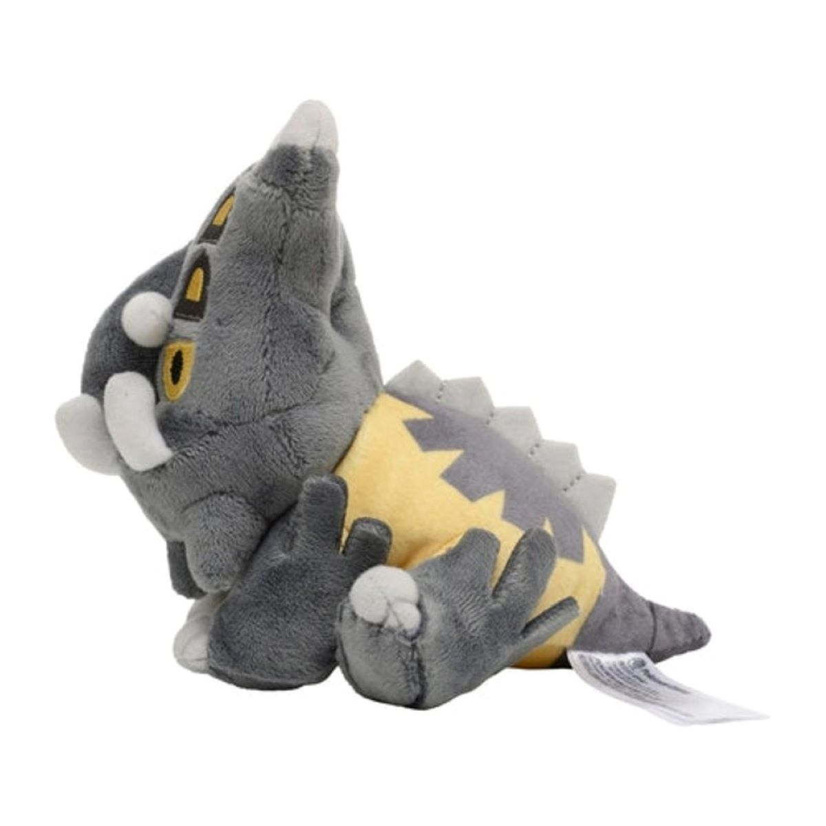 Ein graues Plüschtier-Dinosaurier mit gelbem Bauch und grauen Stacheln, weißen Stoßzähnen und einem Etikett.