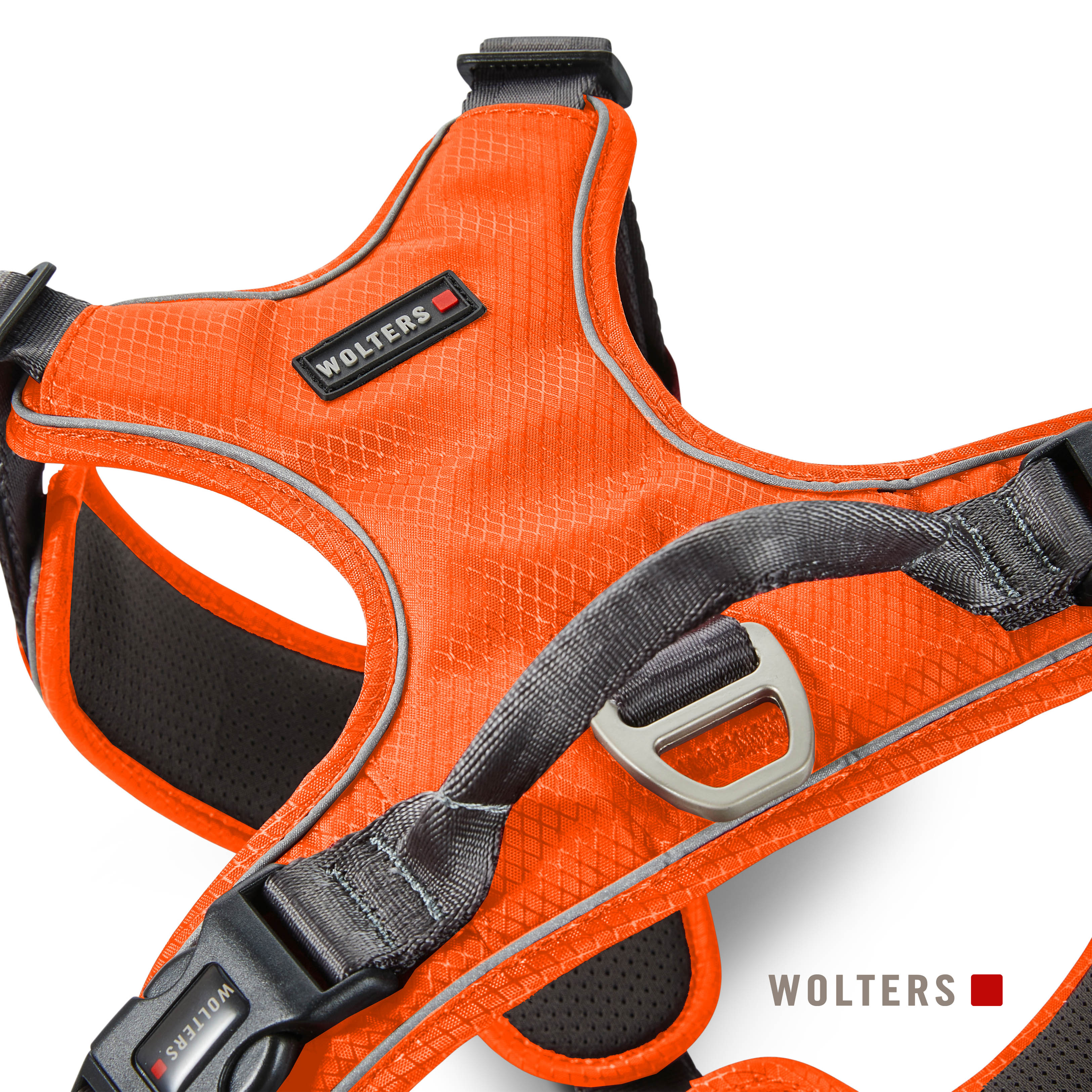Orangener Hundegeschirr mit grauen Akzenten. Mit dem Markennamen 'Wolters'. Enthält eine Schnalle und reflektierende Zierleisten.