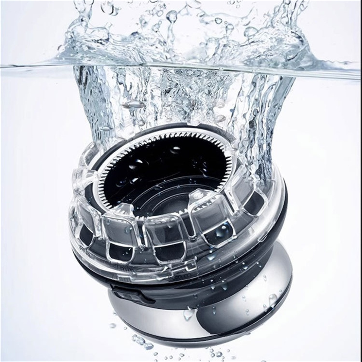 Nahaufnahme eines schwarzen und silbernen Rasierers, der in Wasser getaucht ist, mit spritzendem Wasser vor weißem Hintergrund.