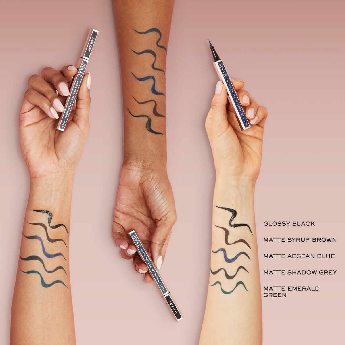 Hände, die Eyeliner-Swatches zeigen: schwarz, braun, blau und grau. Eyeliner-Stifte werden gehalten. Text kennzeichnet Farben. Hintergrund ist rosa.