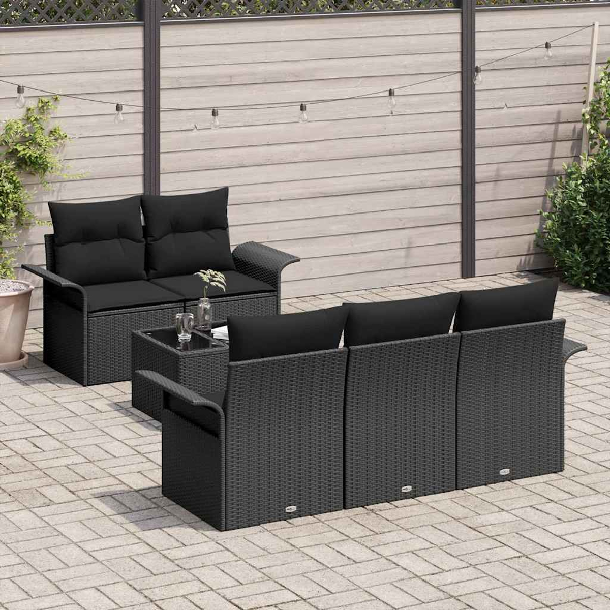 Terrassenset für den Außenbereich mit schwarzen Kissen. Enthält eine Couch, ein Sofa und einen kleinen quadratischen Tisch. Vor einem Holzzaun.