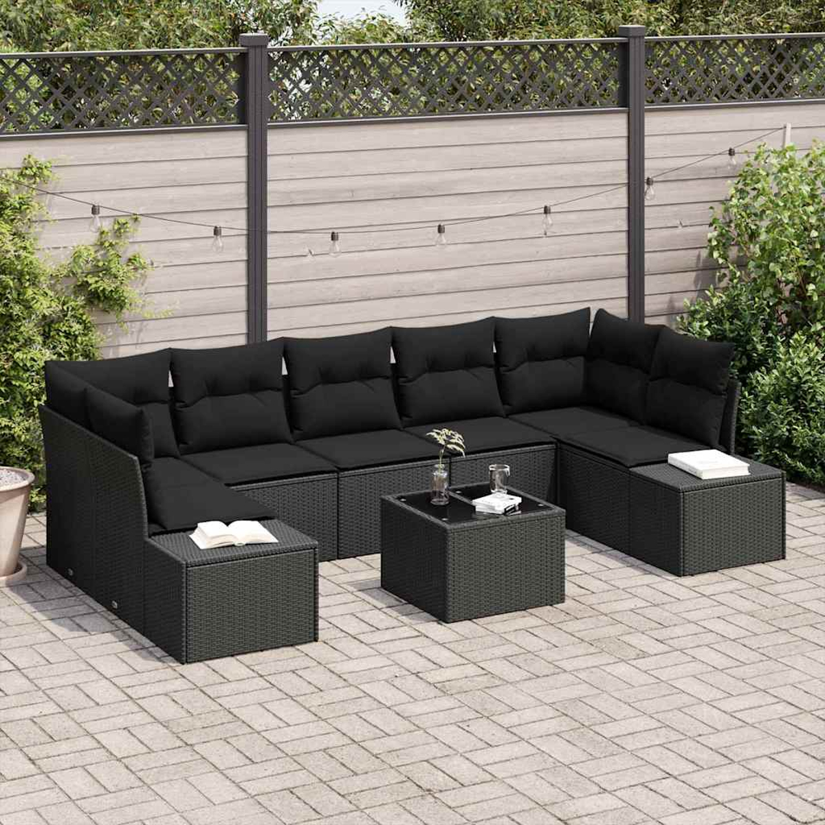 Schwarzes Outdoor-Wicker-Sofa-Set mit Kissen, zwei Hockern und einem quadratischen Tisch auf einer Terrasse.