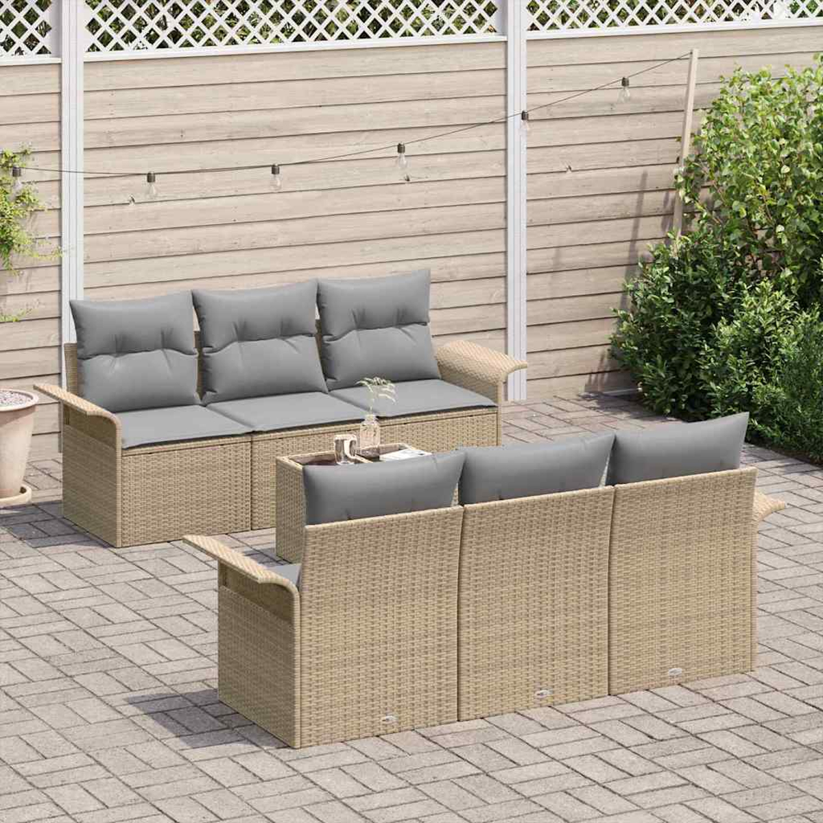 Outdoor-Terrassenset mit zwei beigefarbenen Korbs Sofas mit grauen Kissen auf einer Backsteinterrasse mit Holzzaun im Hintergrund.