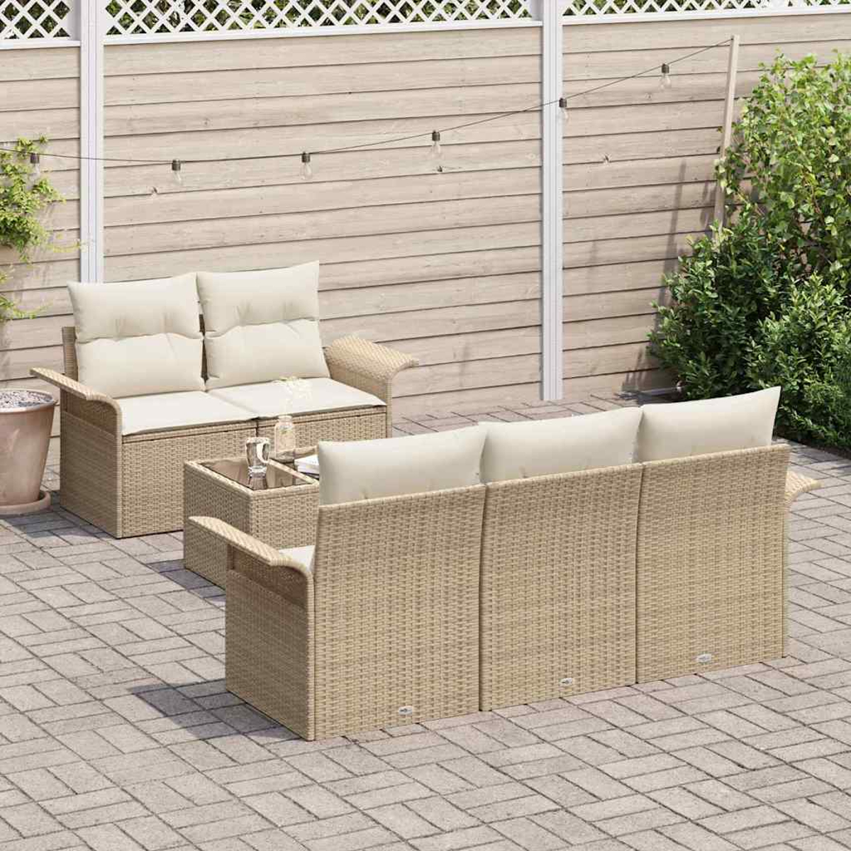 Outdoor-Rattan-Möbelset. Enthält ein Sofa, eine Doppelsitzer-Couch und einen kleinen Tisch. Beige Kissen und gewebte Rahmen auf einer Terrasse mit weißem Zaun.