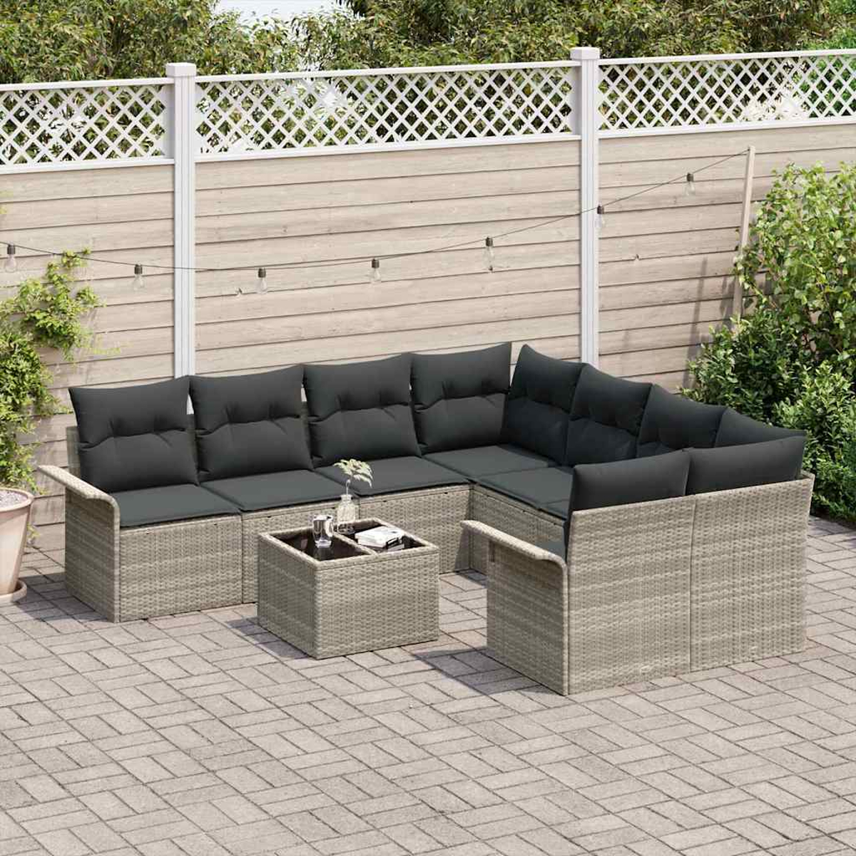 Outdoor-Ecksofa mit dunkelgrauen Kissen und einem kleinen Tisch auf einer Ziegelterrasse. Weißer Zaun und Grün in Hintergrund.