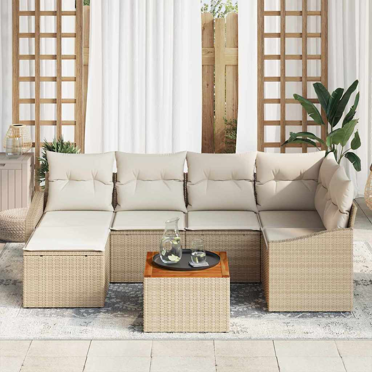 Outdoor-Ecksofa mit cremefarbenen Kissen, einem Holztisch mit Tablett und einem Hintergrund aus weißen Vorhängen und Grün.