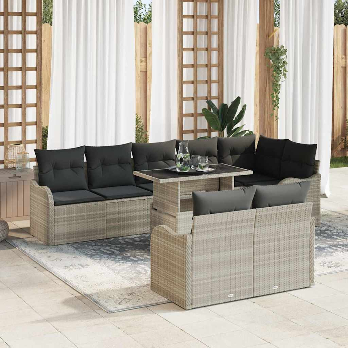 Juego de muebles de exterior: sofá de mimbre gris, mesa y cojines negros. Cortinas blancas y fondo de enrejado de madera. Una alfombra está en el suelo.